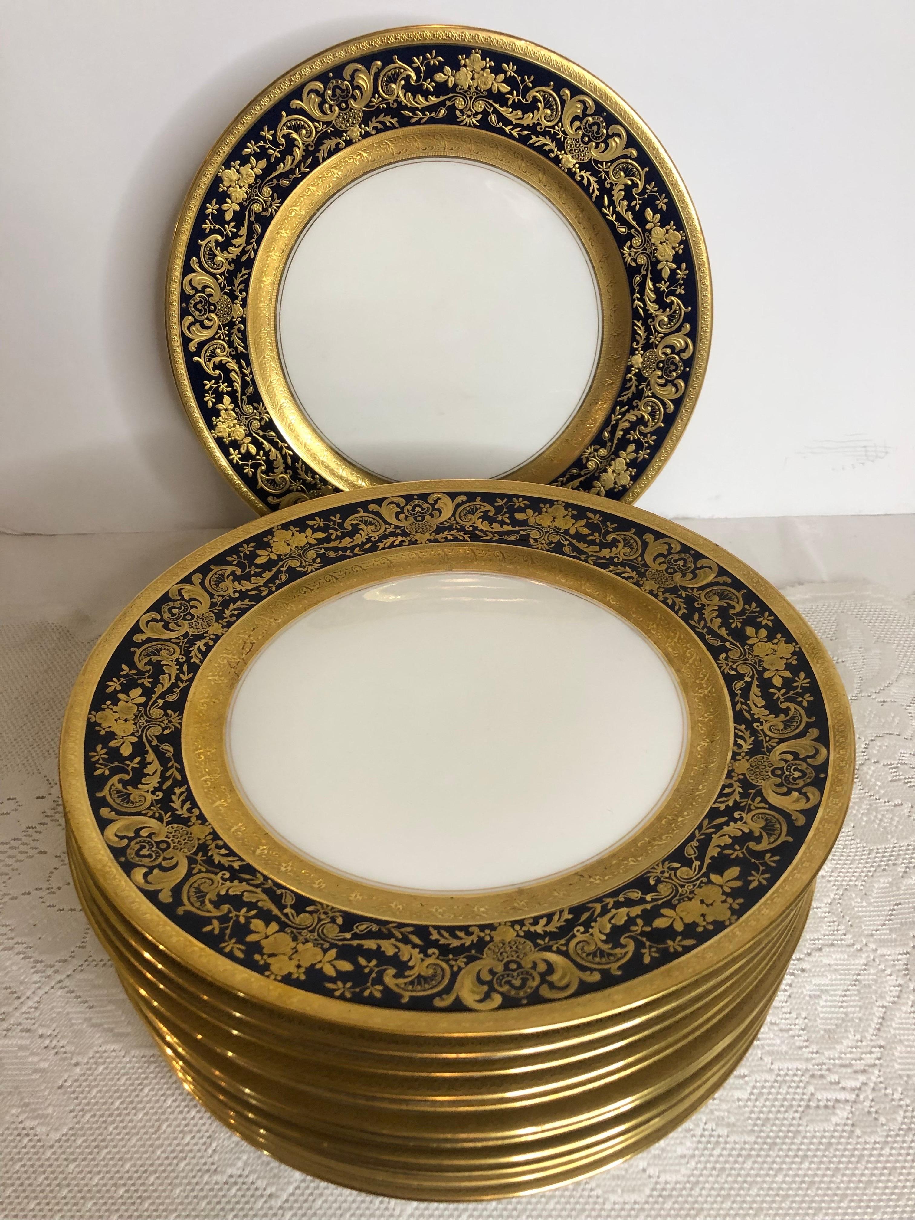 This is a fabulous set of twelve Charles Ahrenfeldt Limoges dinner plates. They have a gold embossed outer border with a thicker gold embossed inner border. In between the two gold embossed borders, is a thick cobalt center. The thick cobalt ring