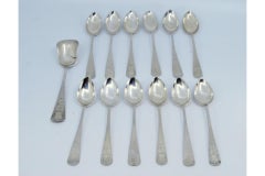 Set of twelve coffee spoons and sugar shovel in brushed and engraved silver