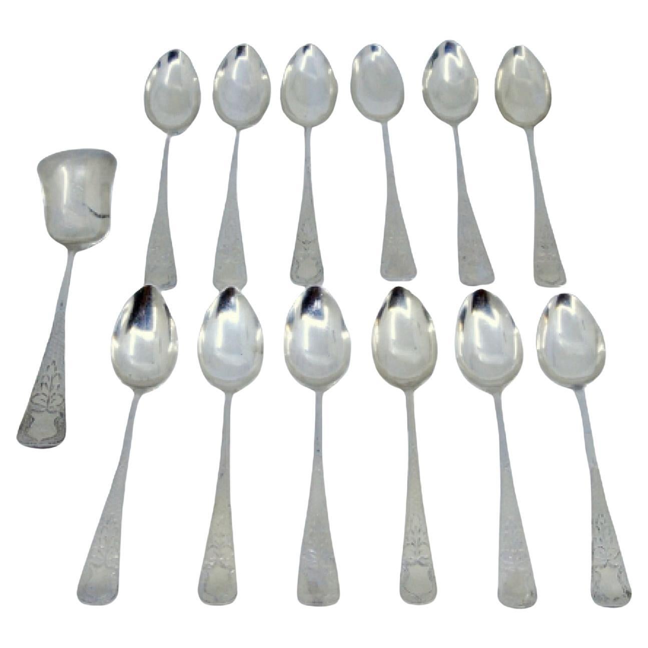 Set of twelve coffee spoons and sugar shovel in brushed and engraved silver