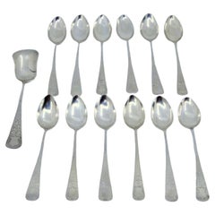 Set of twelve coffee spoons and sugar shovel in brushed and engraved silver