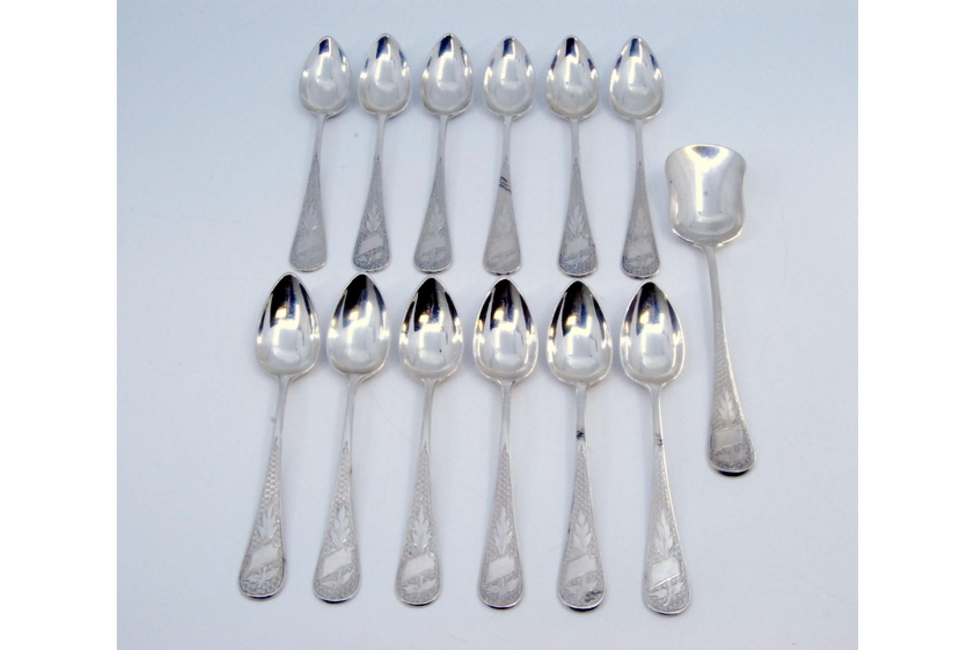 Description: Set of twelve coffee spoons and sugar shovel in guilloche silver with monogram cards. Metal: Silver. Origin: Portuguese. Brand: javali II Title. Weight: 273.09 grams (Set of twelve spoons). Dimensions: Shovel - 14.5x3cm Spoon -