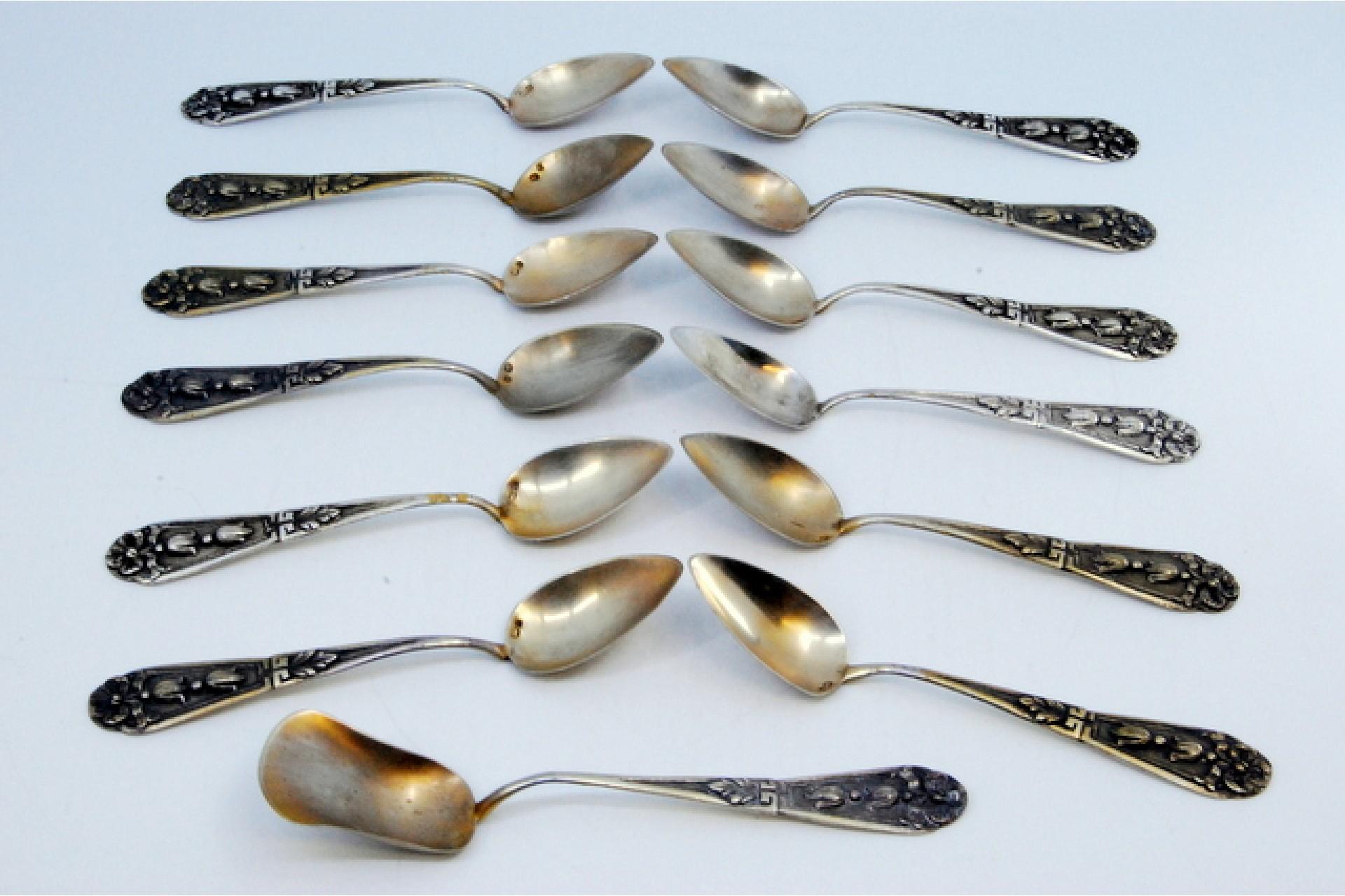 European Set of twelve coffee spoons w/ sugar shovel in embossed silver w/ floral motifs For Sale