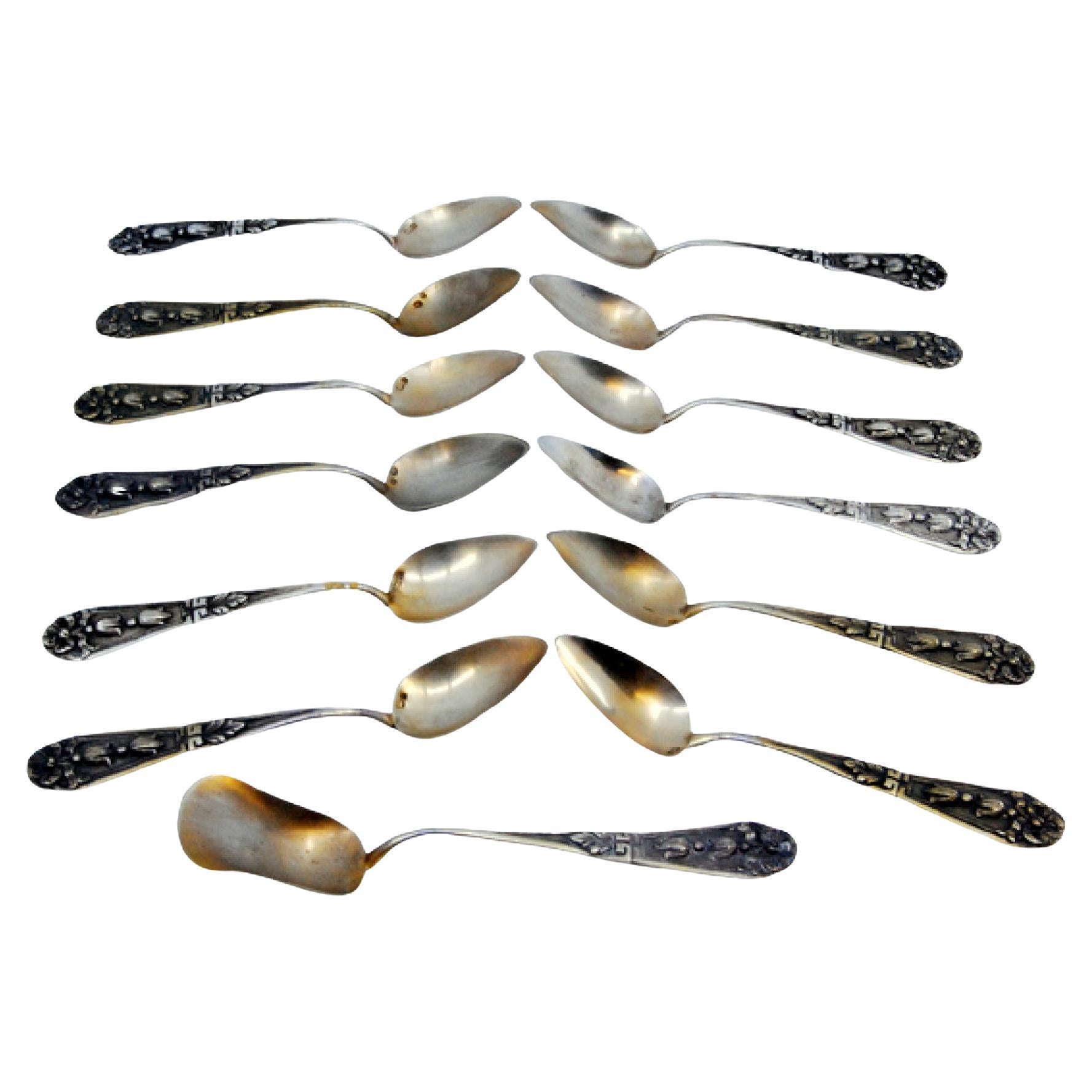 Set of twelve coffee spoons w/ sugar shovel in embossed silver w/ floral motifs