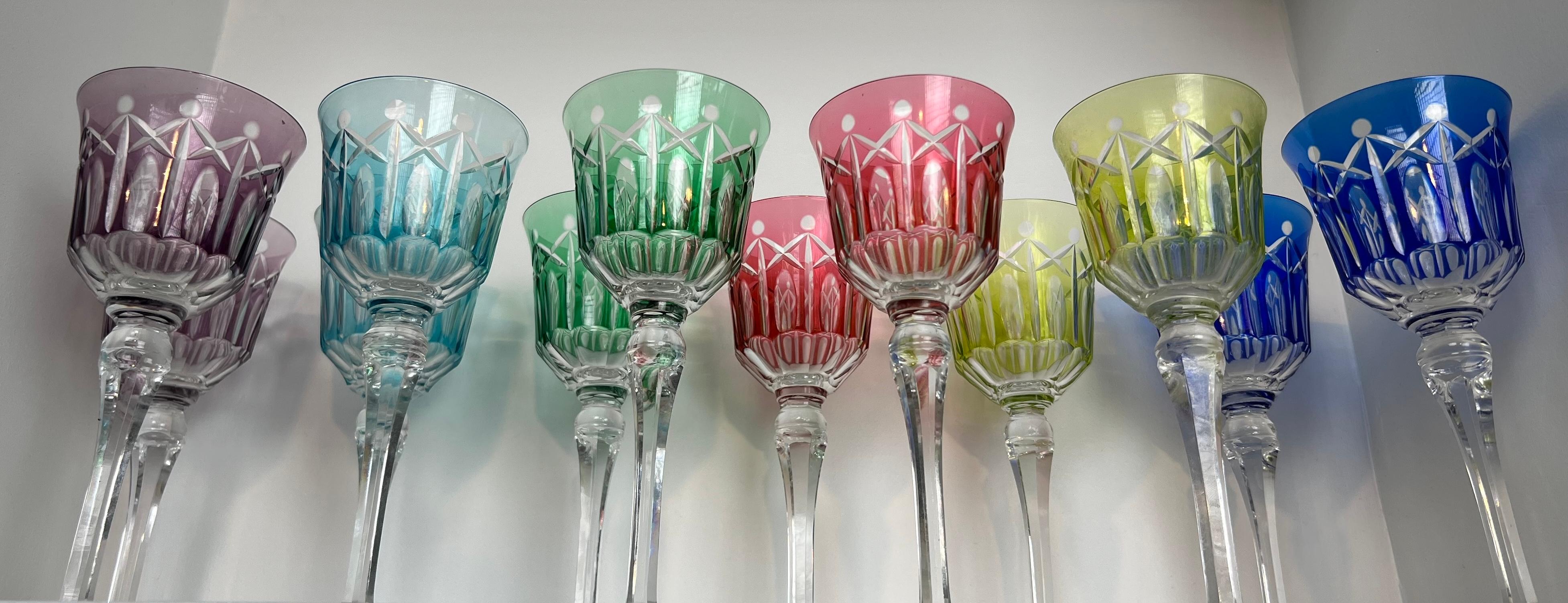 This set of twelve very nice crystal glasses is tinted in different colors and cut with stars. This is a French work. Circa 1930