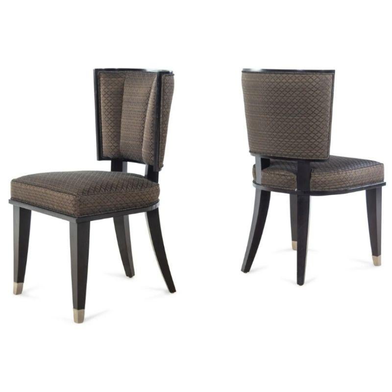 A vintage set of twelve Art Deco style dining chairs with dark wood frames and upholstered in a chocolate brown diamond print fabric with a curved channel back and tapered front legs ending in brass caps, in the manner of Mattaliano.