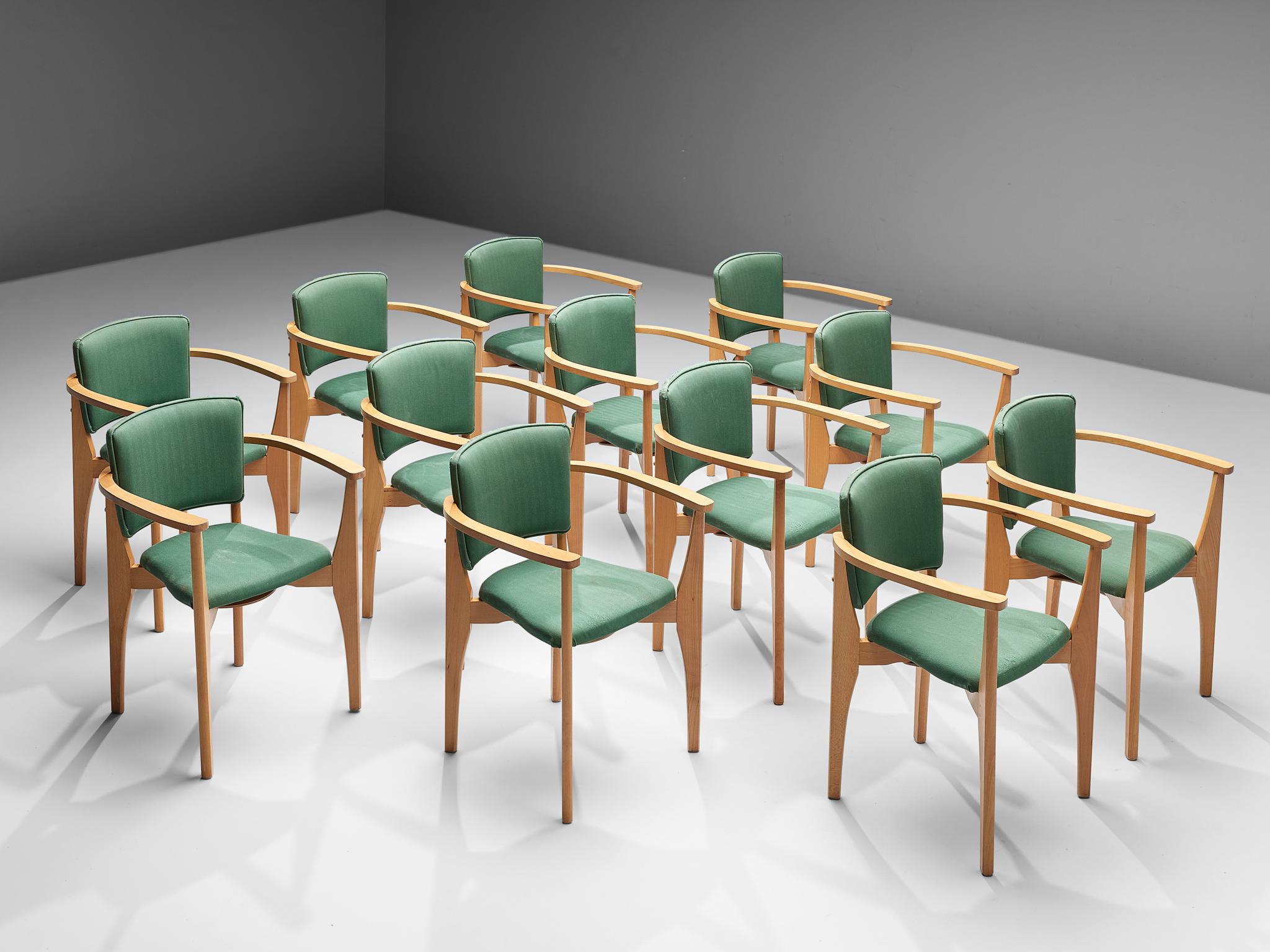 Set of twelve dining chairs, beech, fabric, Europe, 1960s

Set of twelve dining chairs, made in Europe in the 1960s. These dining chairs feature frames in a light beech wood. They show rounded armrests that are connected to the legs in front and at