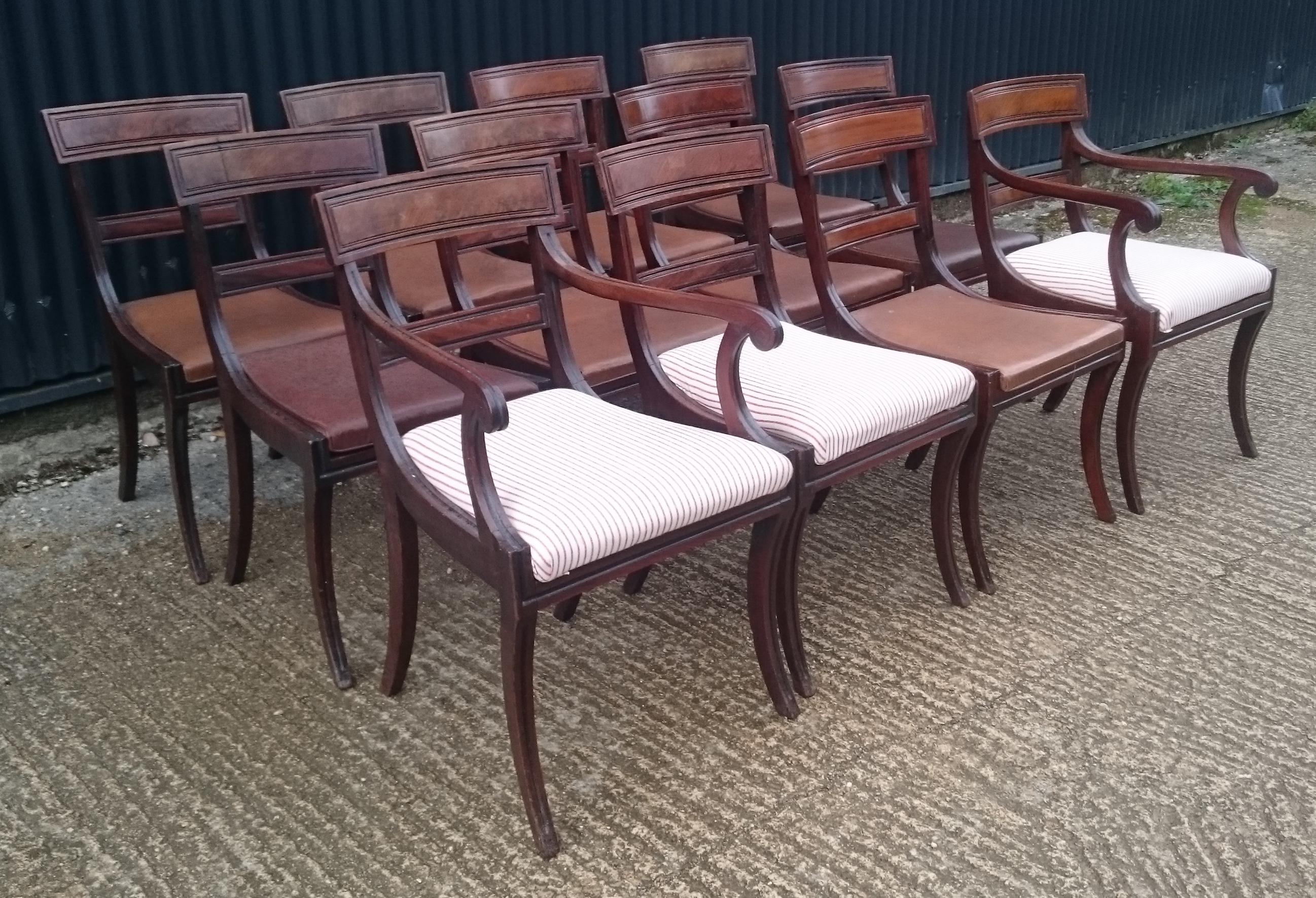 Very fine and well drawn set of twelve early 19th century Regency mahogany antique dining chairs. This set of chairs are larger than normal for the period with good deep seats and a generous splay to the legs. Sabre leg chairs are especially elegant