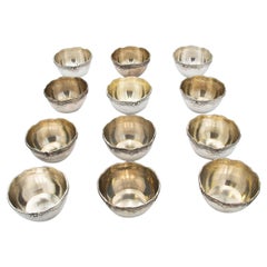 Set of twelve embossed silver washbasins