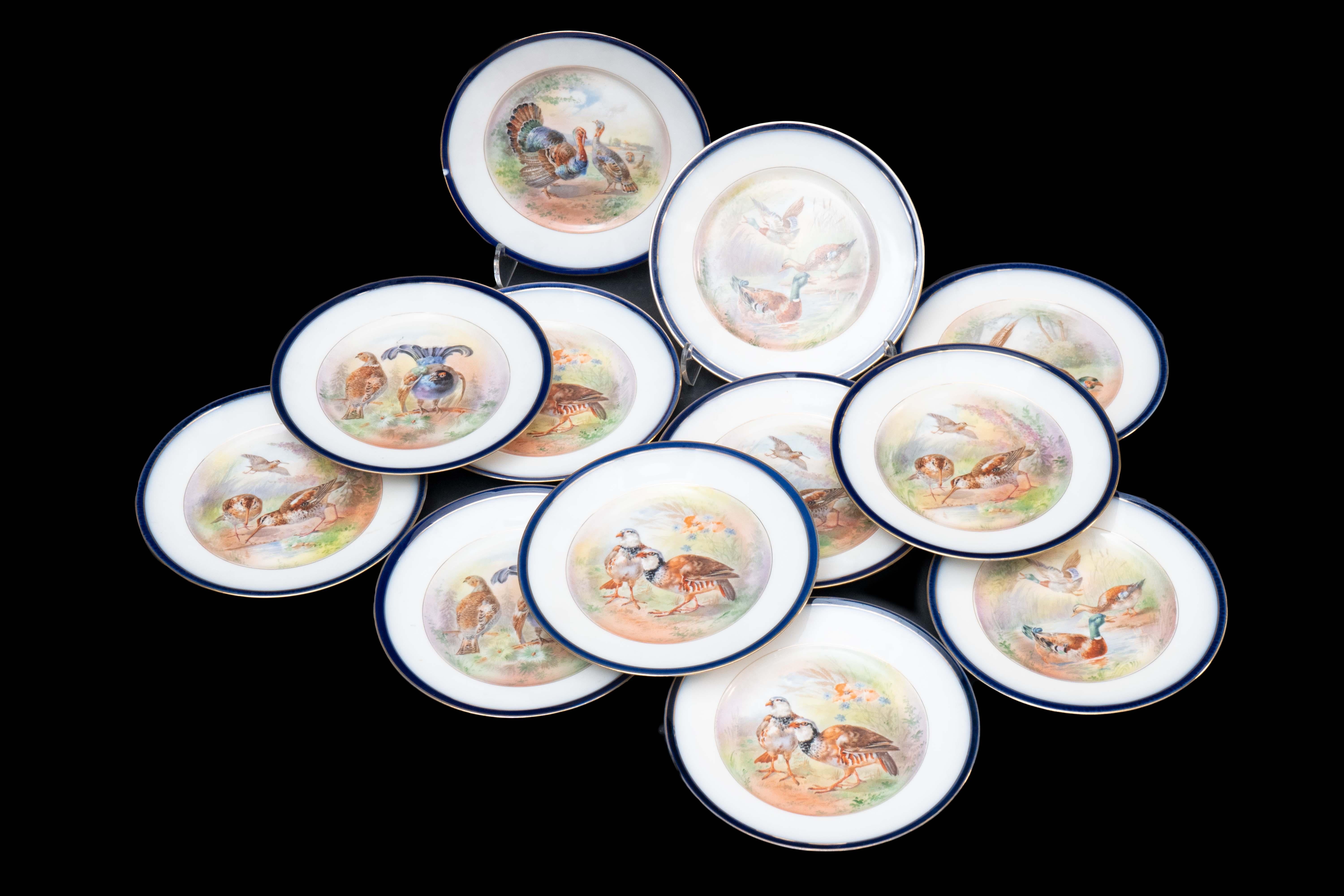 Set of Twelve Exquisite Limoges Game bird plates. Each with cobalt and gilt trim borders- marked by Limoges France.