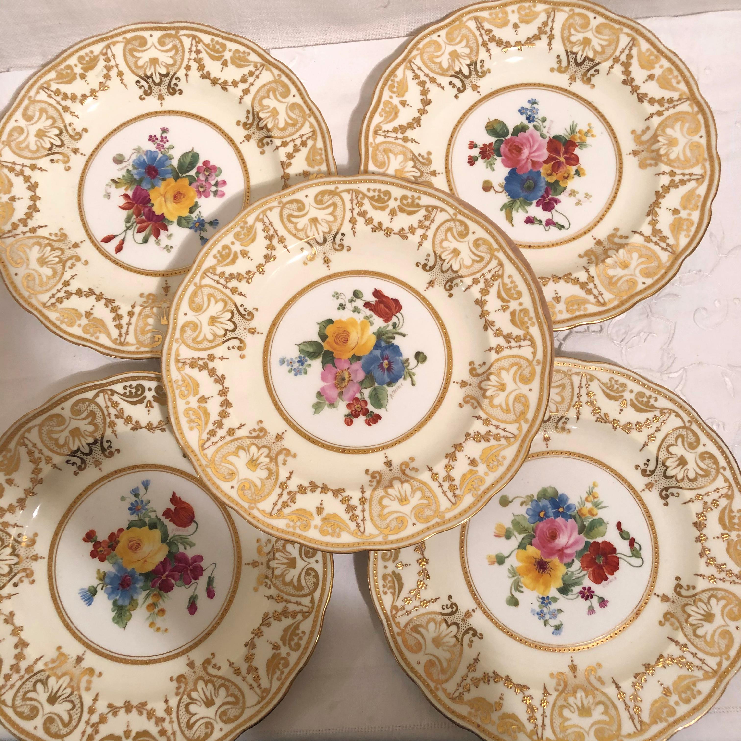Set of twelve English George Jones made for Tiffany & Co. dessert or luncheon plates painted with flower bouquets. They have hand painted bright color flower bouquets which were artist signed B. Cheadle. The borders are a pale yellow ground with