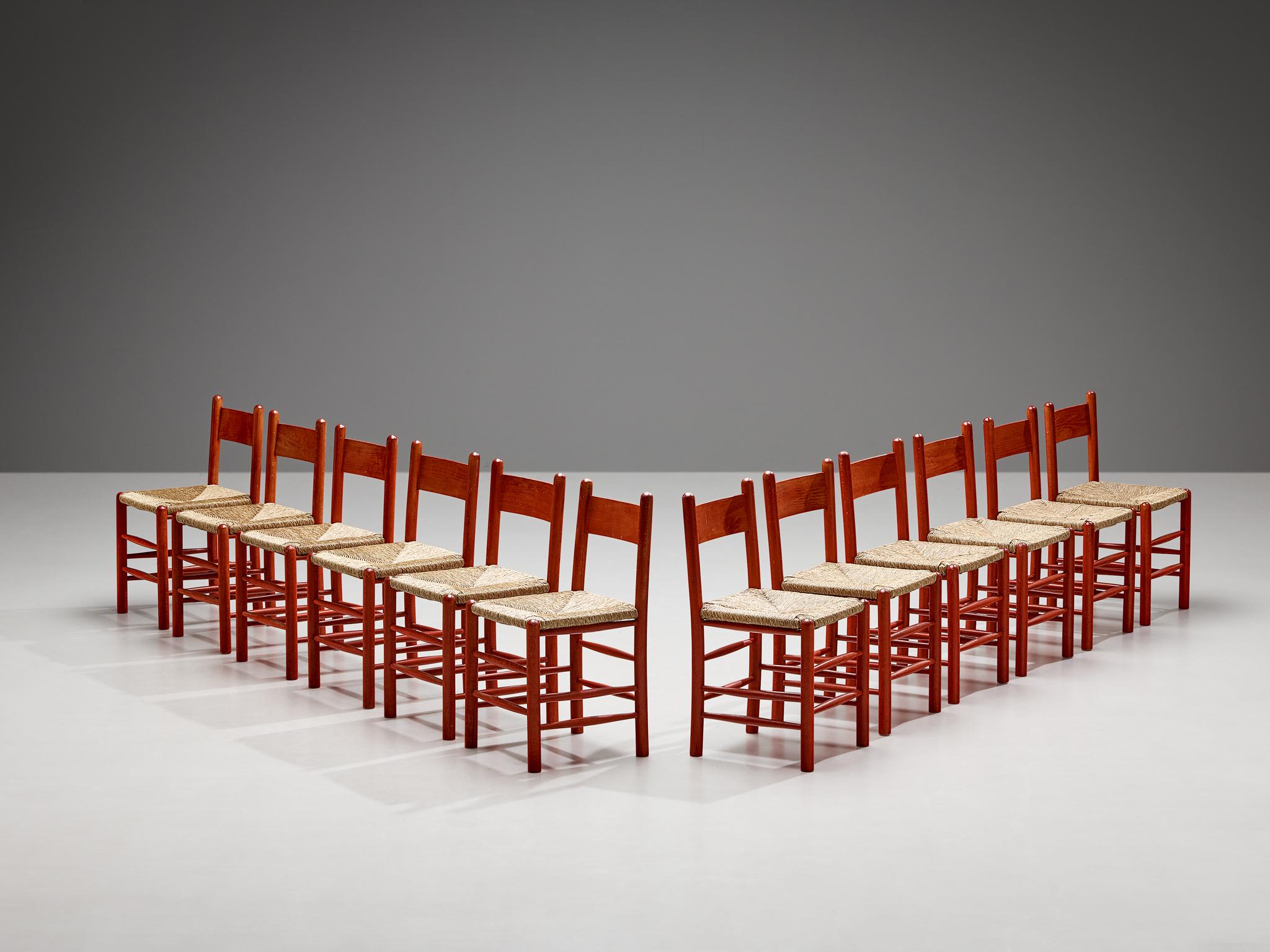 Set of twelve dining chairs, beech, straw, France, 1960s.

Stunning set of twelve French chairs with red beech frames and classic organic straw seats. This set of twelve dining chairs features a solid wooden frame, consisting of cylindrical thick
