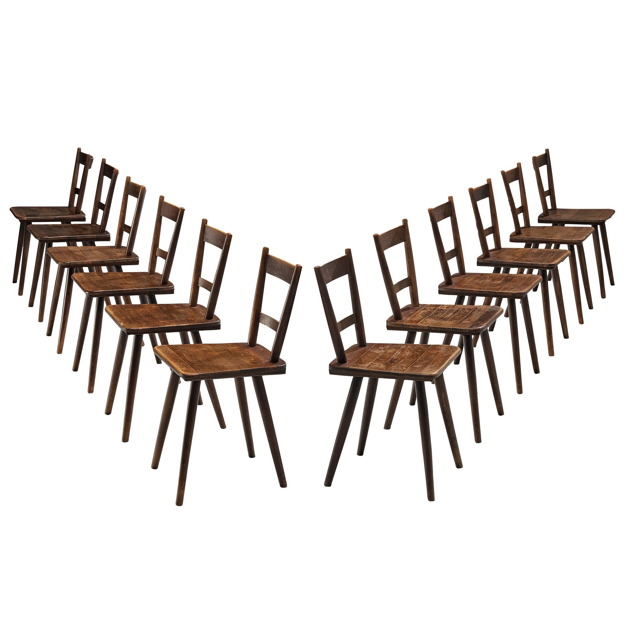 Set of Twelve French Pastoral Dining Chairs in Stained Wood