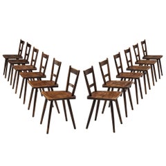 Set of Twelve French Pastoral Dining Chairs in Stained Wood