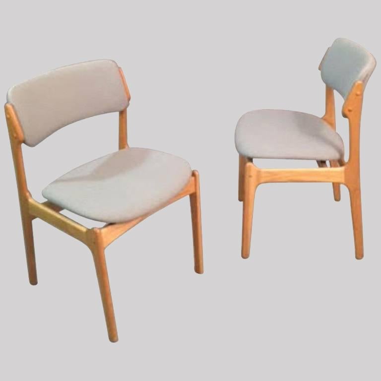 Set of twelve fully restored Danish dining chairs inc. reupholstery designed by Erik Buch in 1949.

The chairs have a simple solid construction with elegant organic curves and corners and a very comfortable seating experience on the floating seat