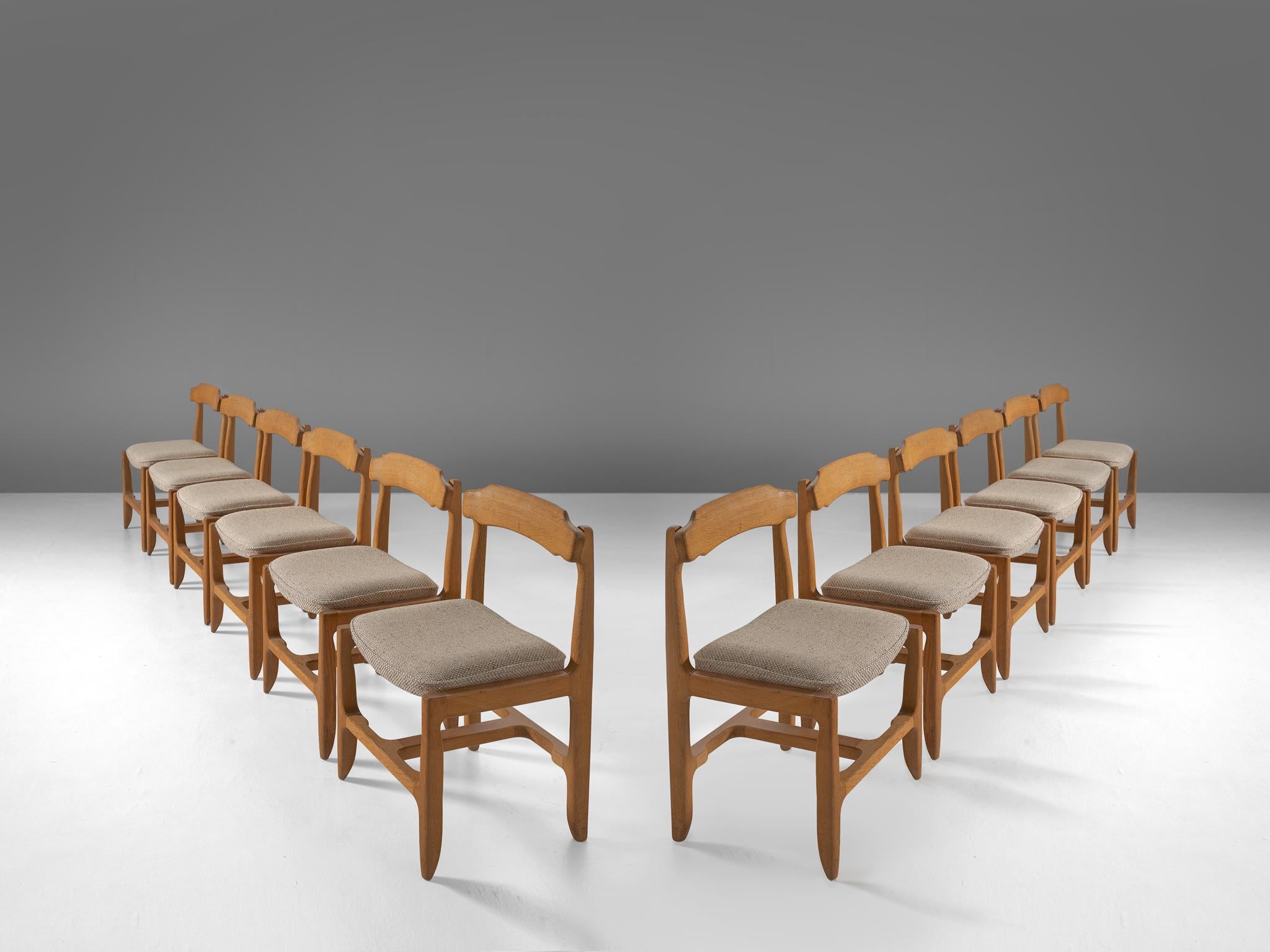 Guillerme et Chambron, set of 12 dining chairs, solid oak, grey upholstery, France, 1960s.

These distinctive chair in beautifully patinated oak is by the French designer duo Jacques Chambron (1914-2001) and Robert Guillerme, (1913-1990). These