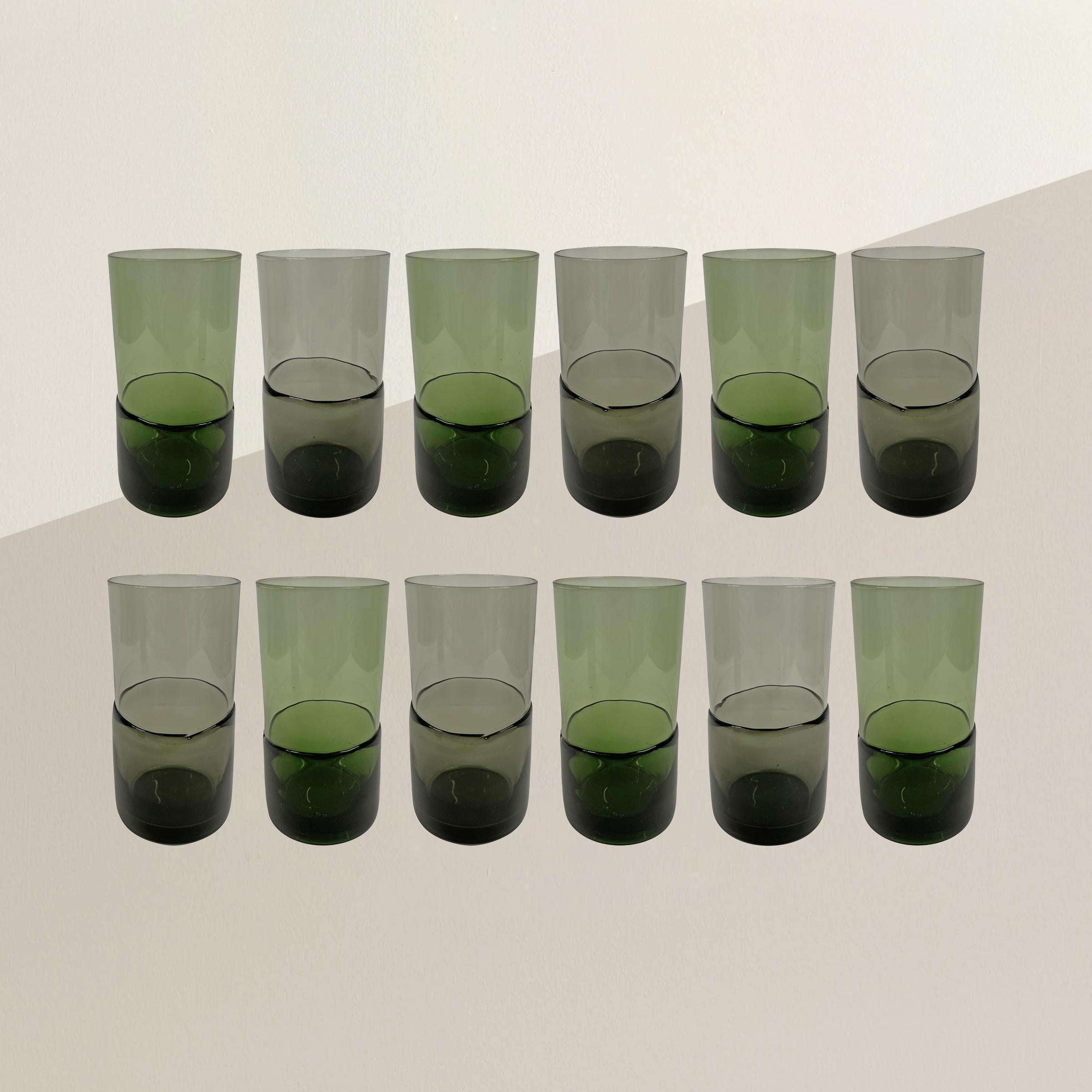 A chic set of twelve hand blown drinking glasses in varying shades of gray and green. Perfect for your next family get-together or cocktails with friends.