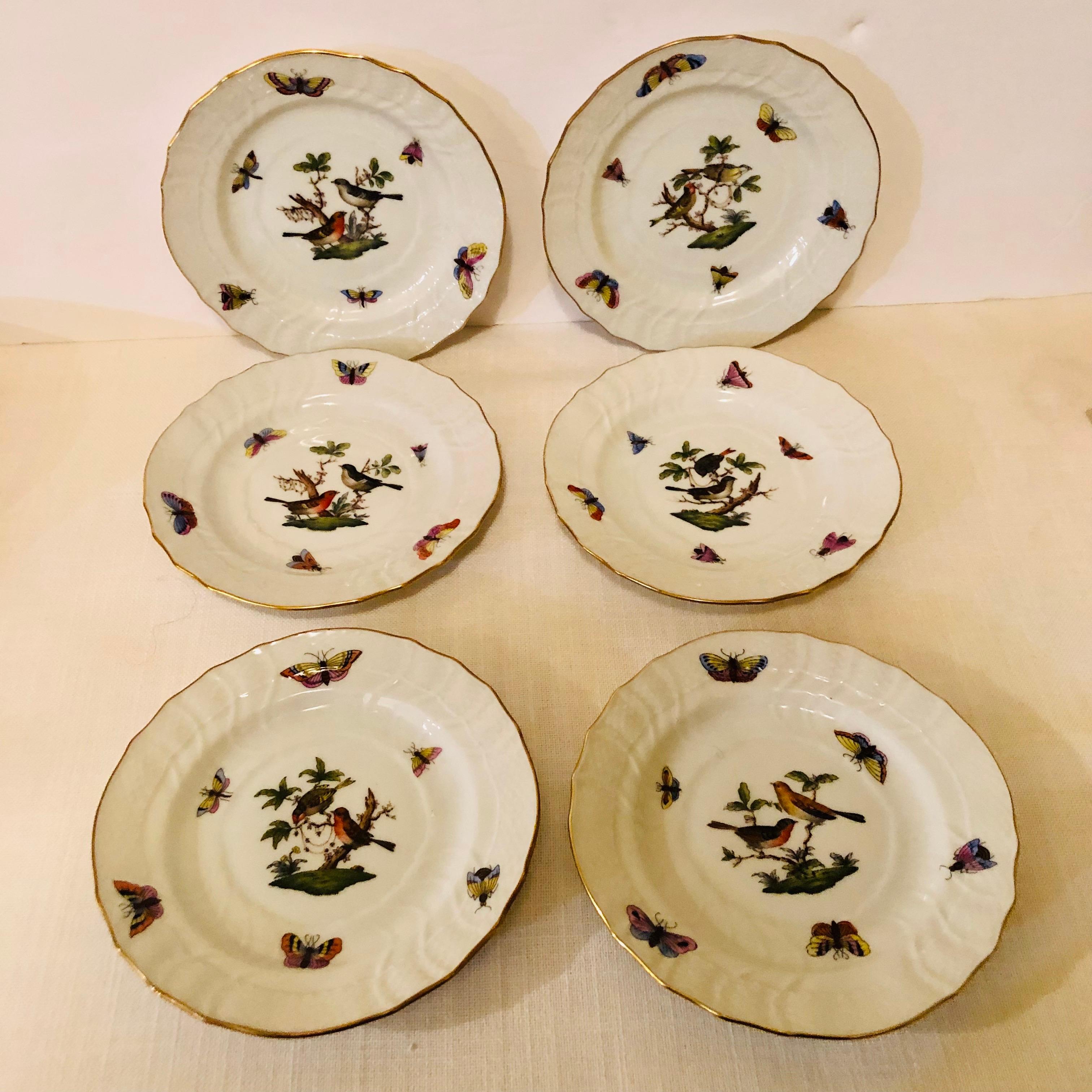 These are a set of twelve Herend Rothschild Bird bread or appetizer plates, each hand painted with two birds decorated with accents of colorful butterflies and insects. This set would be a wonderful addition to any dinner service. It is an beautiful