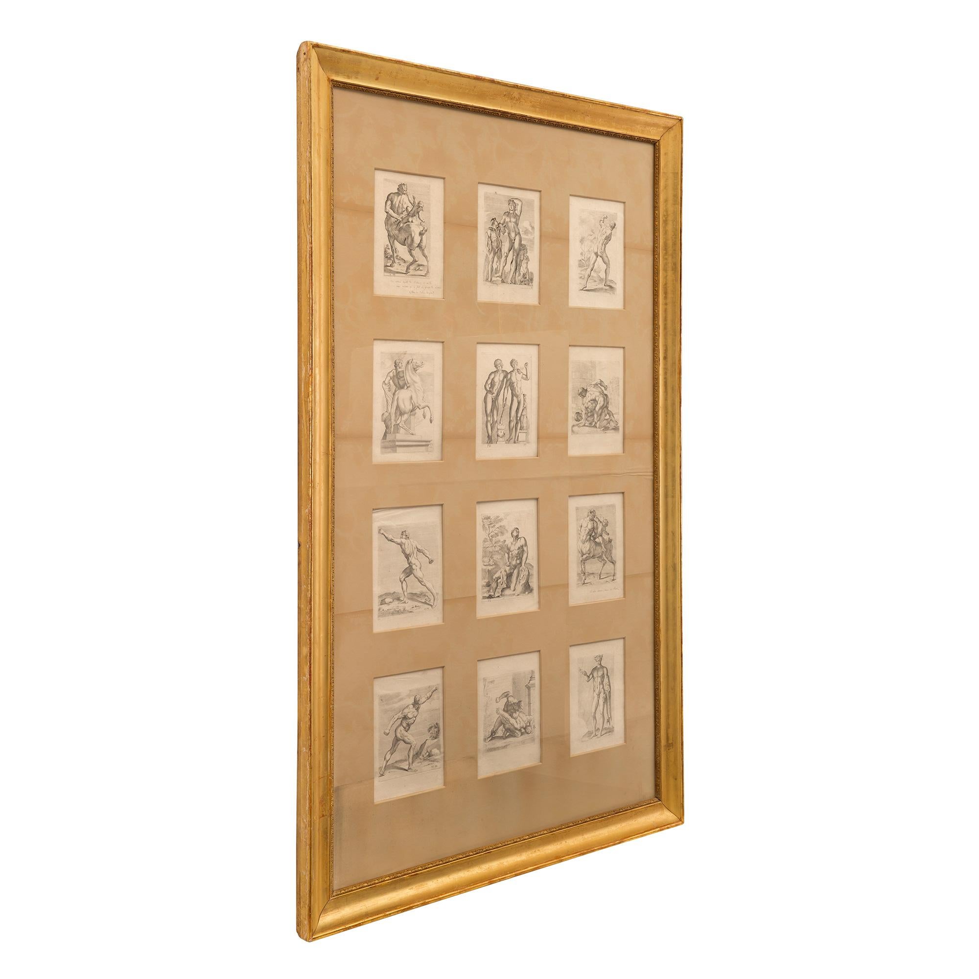 An elegant and most decorative set of twelve Italian 19th century Neo-Classical prints set in a giltwood frame. Each beautiful print displays wonderfully executed Greek and Neo-Classical figures. The prints depict wrestlers, Olympians and elegant