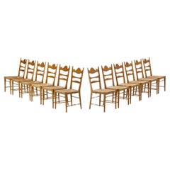 Satz von zwölf italienischen Esszimmerstühlen mit geschnitzten Rückenlehnen und Strohsitzen 