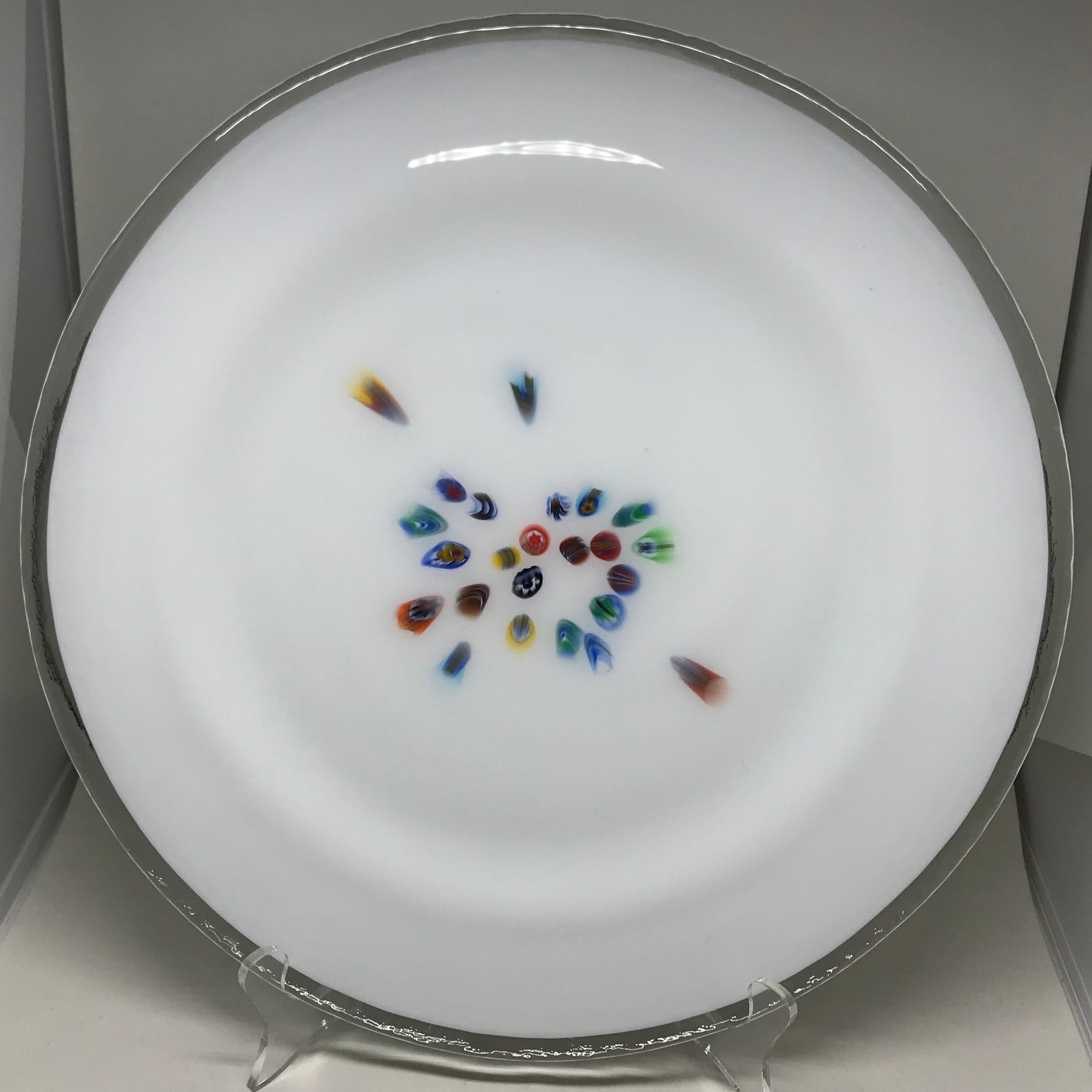 Set of twelve Italian modern glass plates. Set of twelve Murano white glass modernist plates each individually crafted in the millefiori technique with different pattern of colored glass to each plate, all with clear glass rims, Italy, 20th