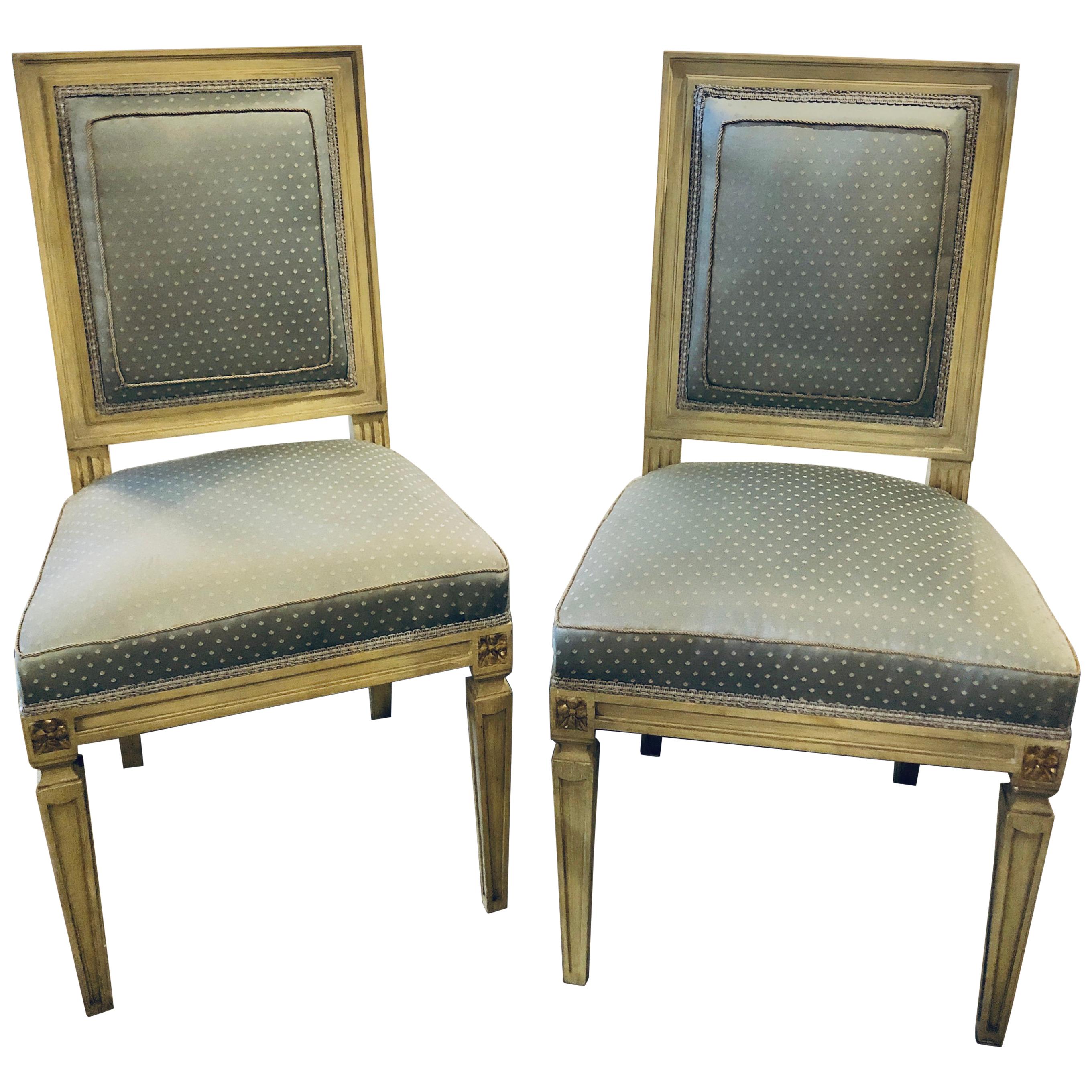 Set of eleven Jansen style paint decorated and Gilt Louis XVI style dining chairs. Each in a new upholstery with new springs and welts. The set with fine sleek and clean lines in a linen grayish form of parchment faux paint with gilt hi lights. The