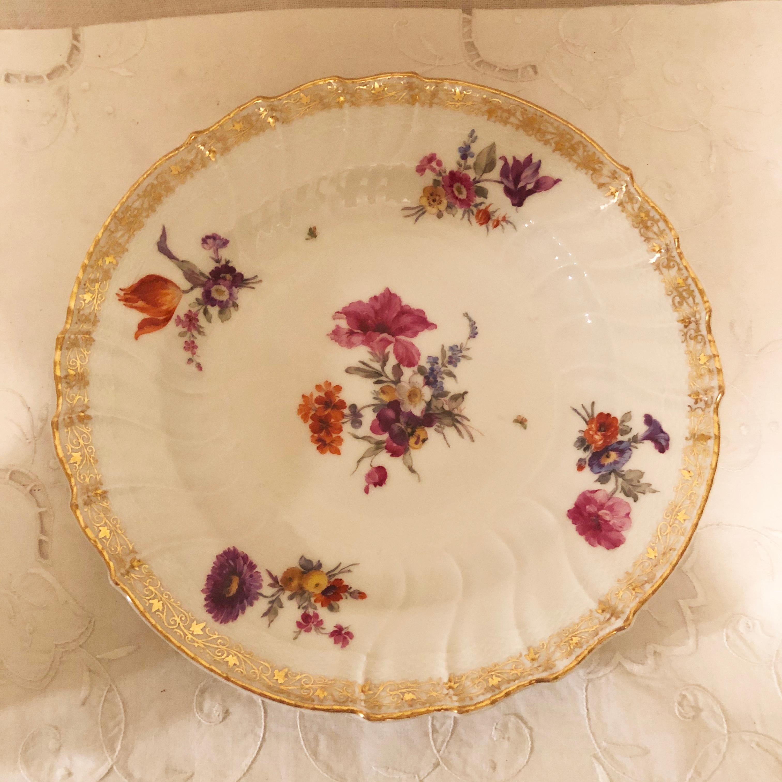 Set of twelve KPM dinner plates with different museum quality hand painted floral bouquets on each plate. KPM is also known as the Konigliche Porzellan-Manufaktur of Germany. They had very talented artists who did an outstanding job of painting on