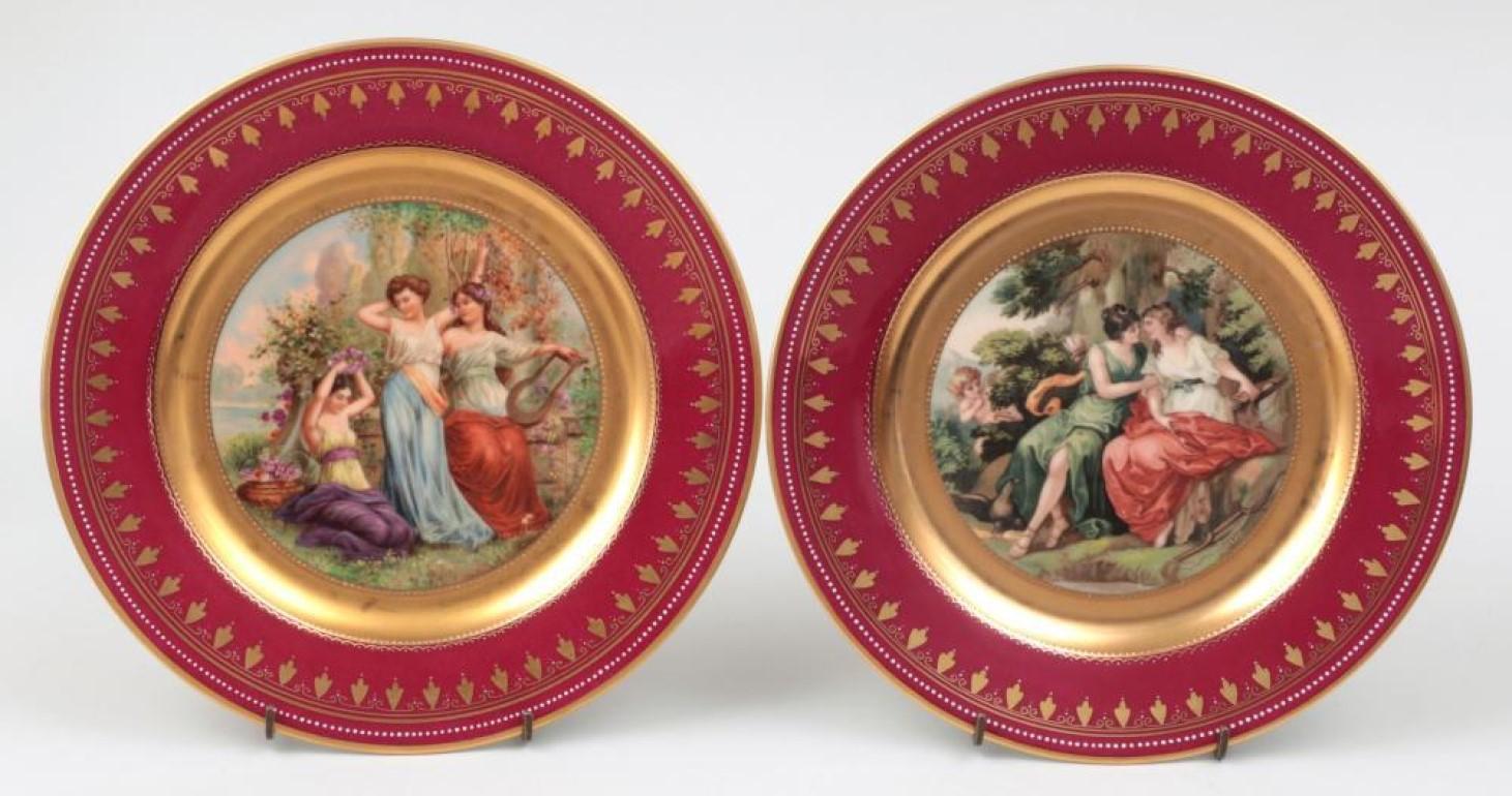 Set of twelve late 19th century Royal Vienna portrait plates with crimson borders, each with different scene, transfer with hand painted details, marked and titled to verso, all signed.