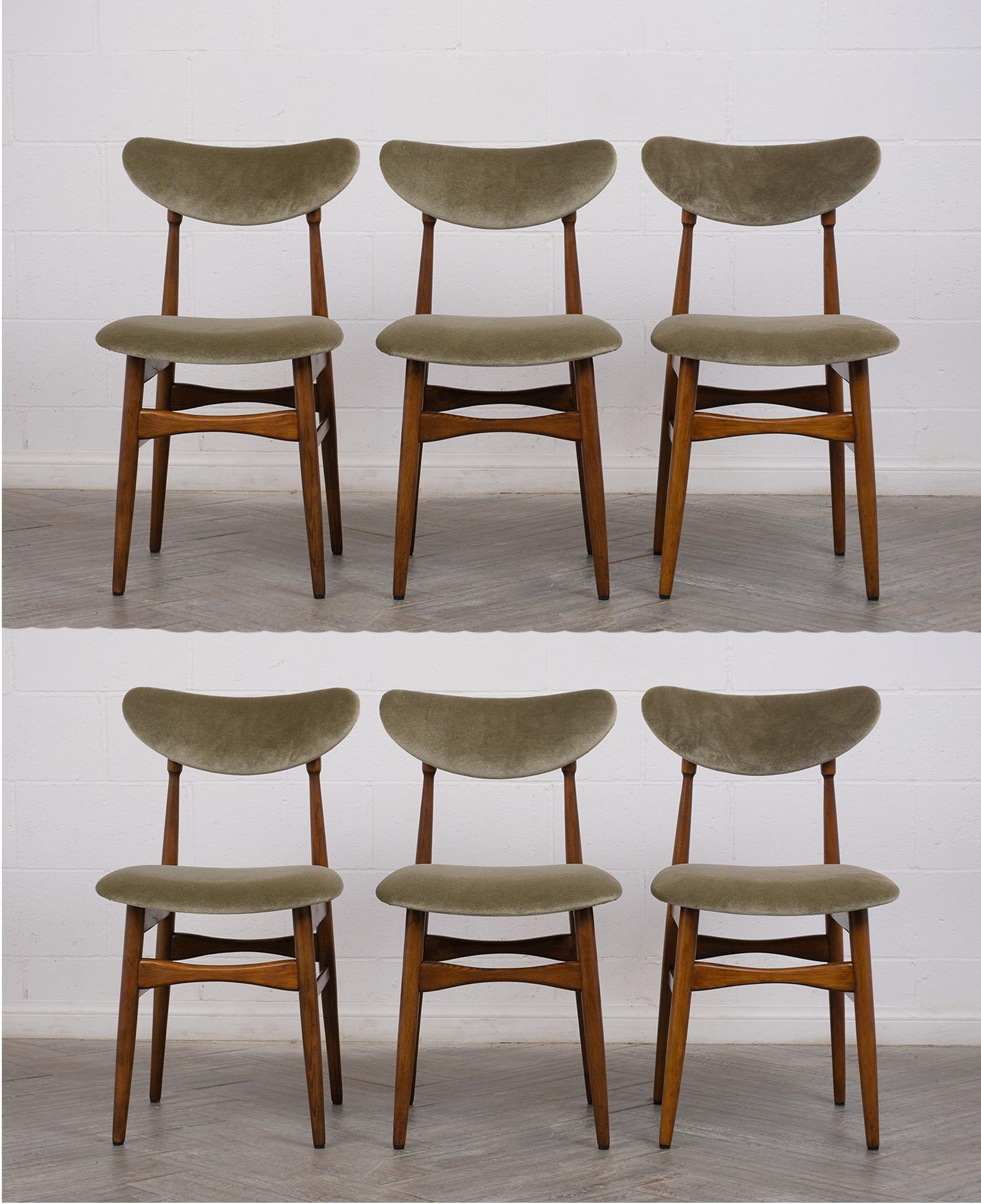 This set of twelve Mid-Century Modern style dining chairs are newly restored and in great condition. This set features walnut wood frames that are a dark walnut color with lacquer finish. The frames have a simple sleek design and are very sturdy.