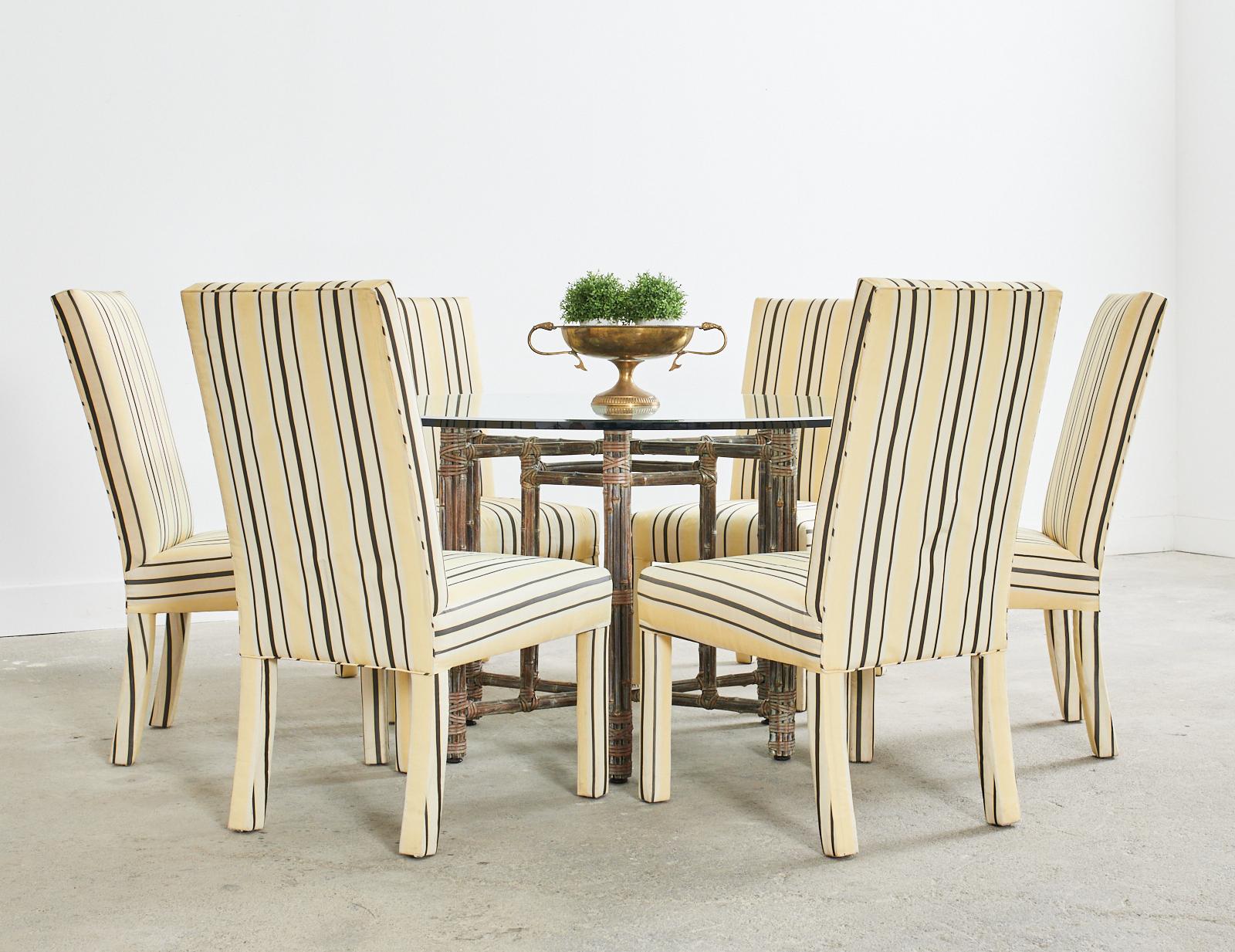 Matching set of twelve Mid-Century Modern Parsons dining chairs upholstered with a silk style striped fabric. Excellent joinery and craftsmanship with vintage fabric that is faded and showing signs of wear. Bespoke set of chairs with generous seats