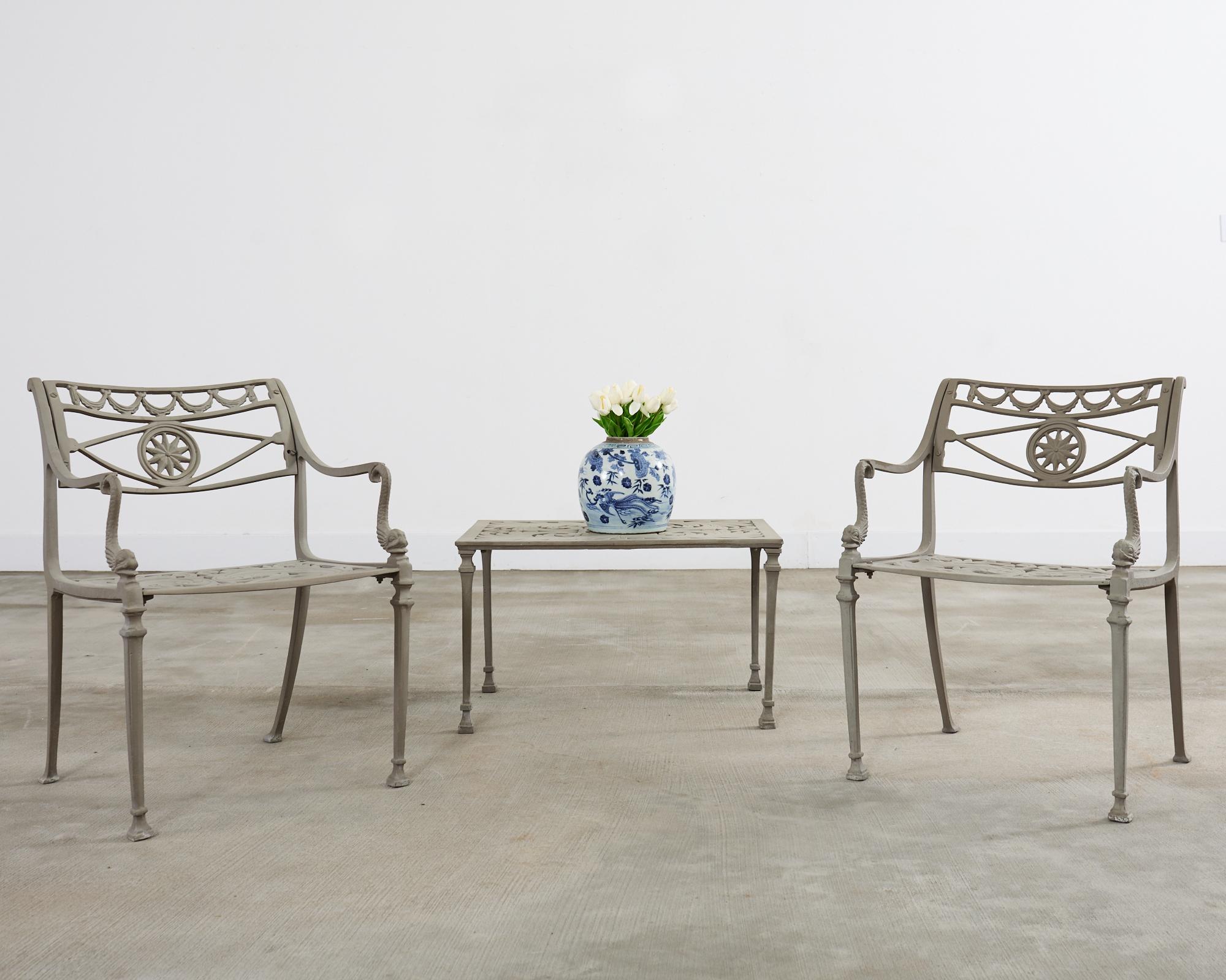 Grand set of twelve patio and garden dolphin and star dining chairs attributed to Kenneth Lynch and Sons, Oxford, CT. The set consists of all armchairs with the optional filagree seat having a scrolled acanthus motif in the neoclassical taste. The