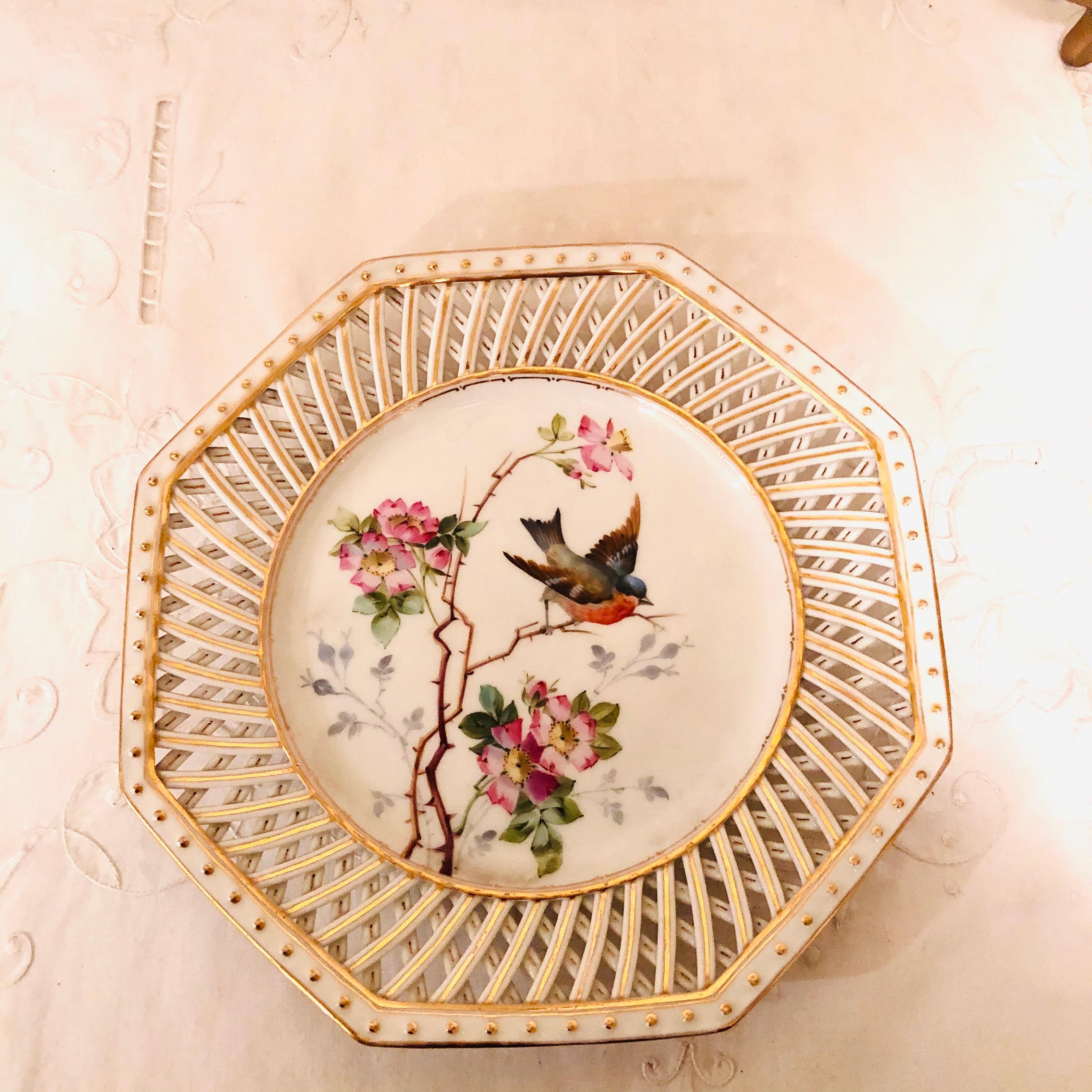 Set of twelve Pirkenhammer reticulated octagonal bird plates, each hand painted with different birds in their natural habitat. The paintings of the birds, flowers and leaves are influenced by the aesthetic movement. Around the octagonal border of