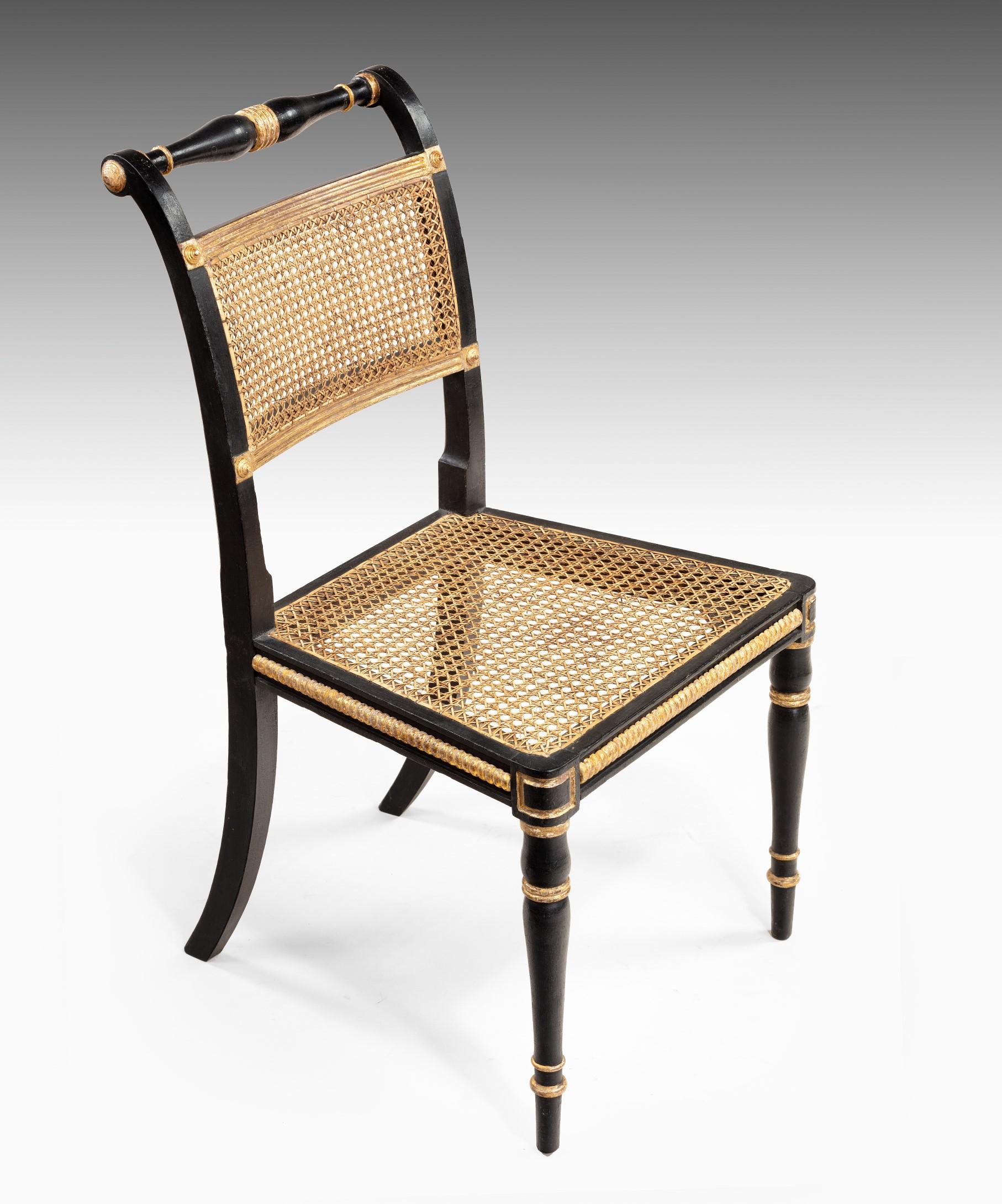 Early 19th Century Set of Twelve Regency Dining Chairs in Ebonized and Gilded Decoration