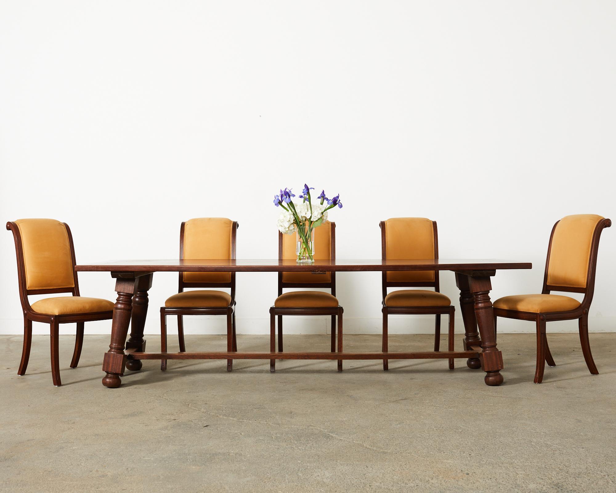 Distinctive set of twelve dining chairs crafted by Lily Jack in Gardena, CA. The set consists of all side chairs made in the English Regency taste. The frames feature a tall scrolled back with reeded sides. The generous seats are upholstered with a