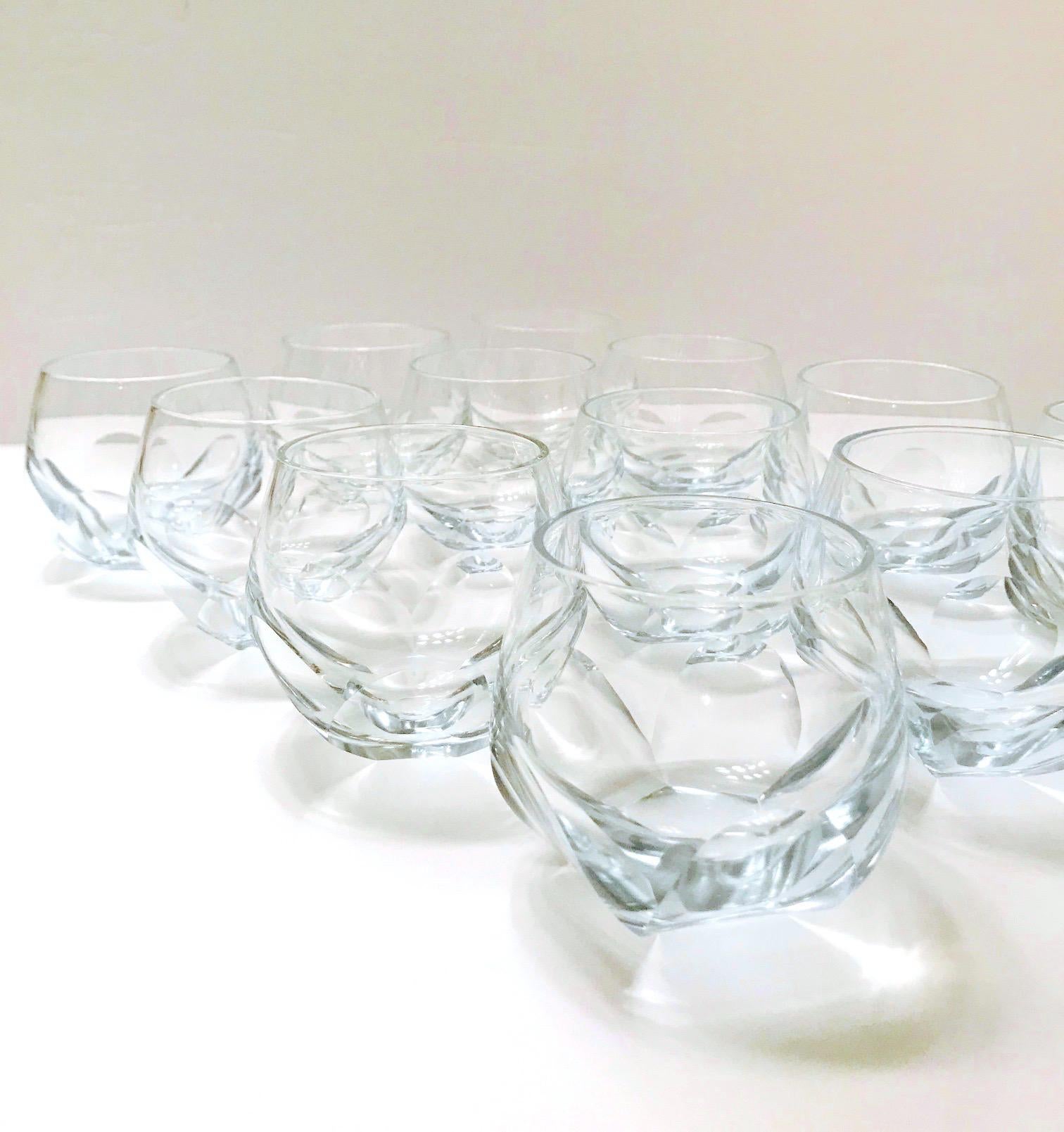 Set of twelve vintage barware glasses with faceted design. The rock glasses have chic round bubble forms with handcut prism bases much like a glass honeycomb. Hand blown glass with a very subtle pale blue cast. Makes a handsome addition to any