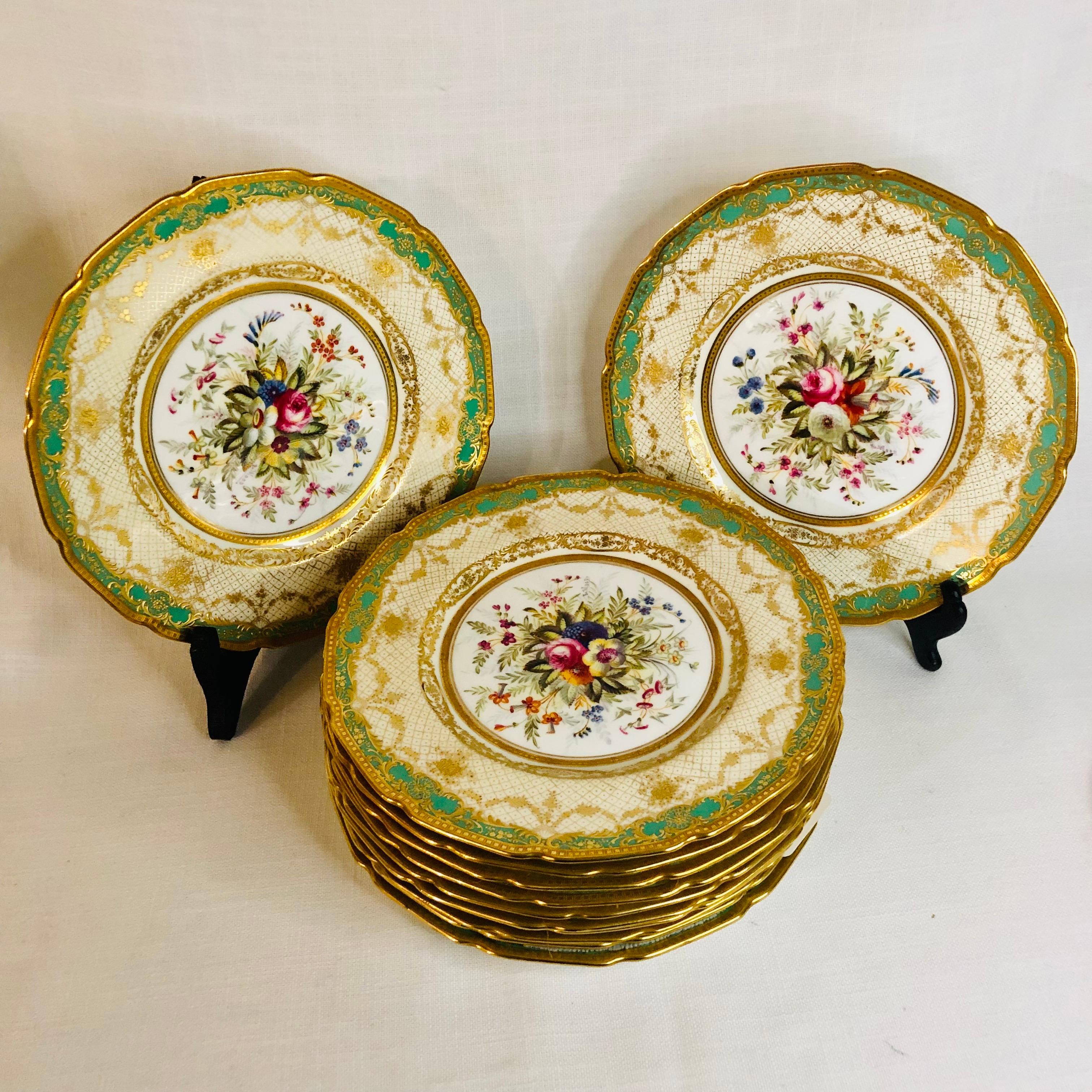 I am offering you this exquisite set of twelve Royal Doulton museum quality plates artist signed E. Wood. Each plate is painted beautifully with different bouquets of flowers with raised gilded ribbon accents around the inside of the green and gold