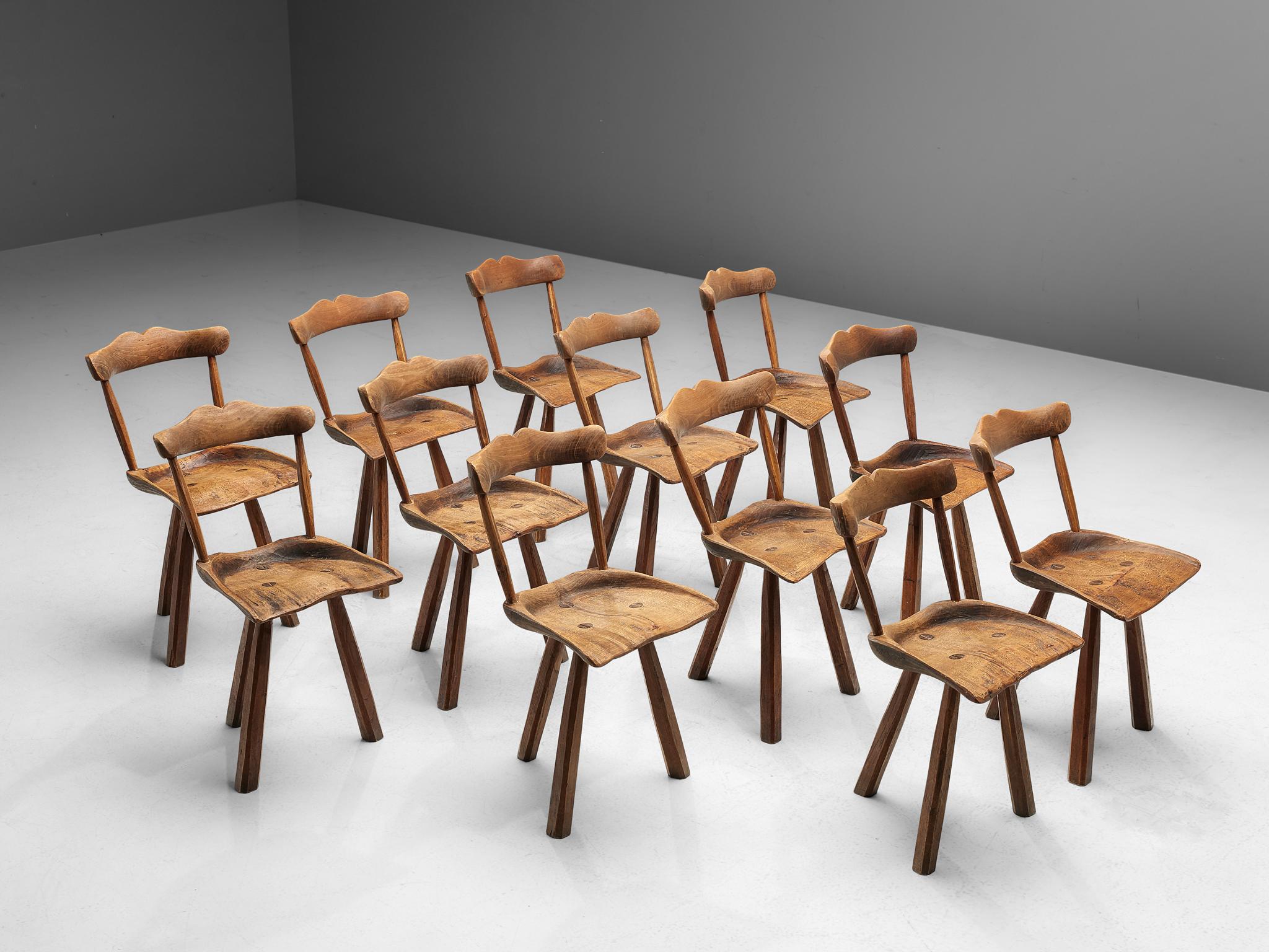 Set of twelve rustic dining chairs, beech, chestnut, Europe, 1950s

The set of twelve dining chairs consists out of beech and three chestnut wooden legs. Their rustic appearance is matched with important design details. Per example the visibility of
