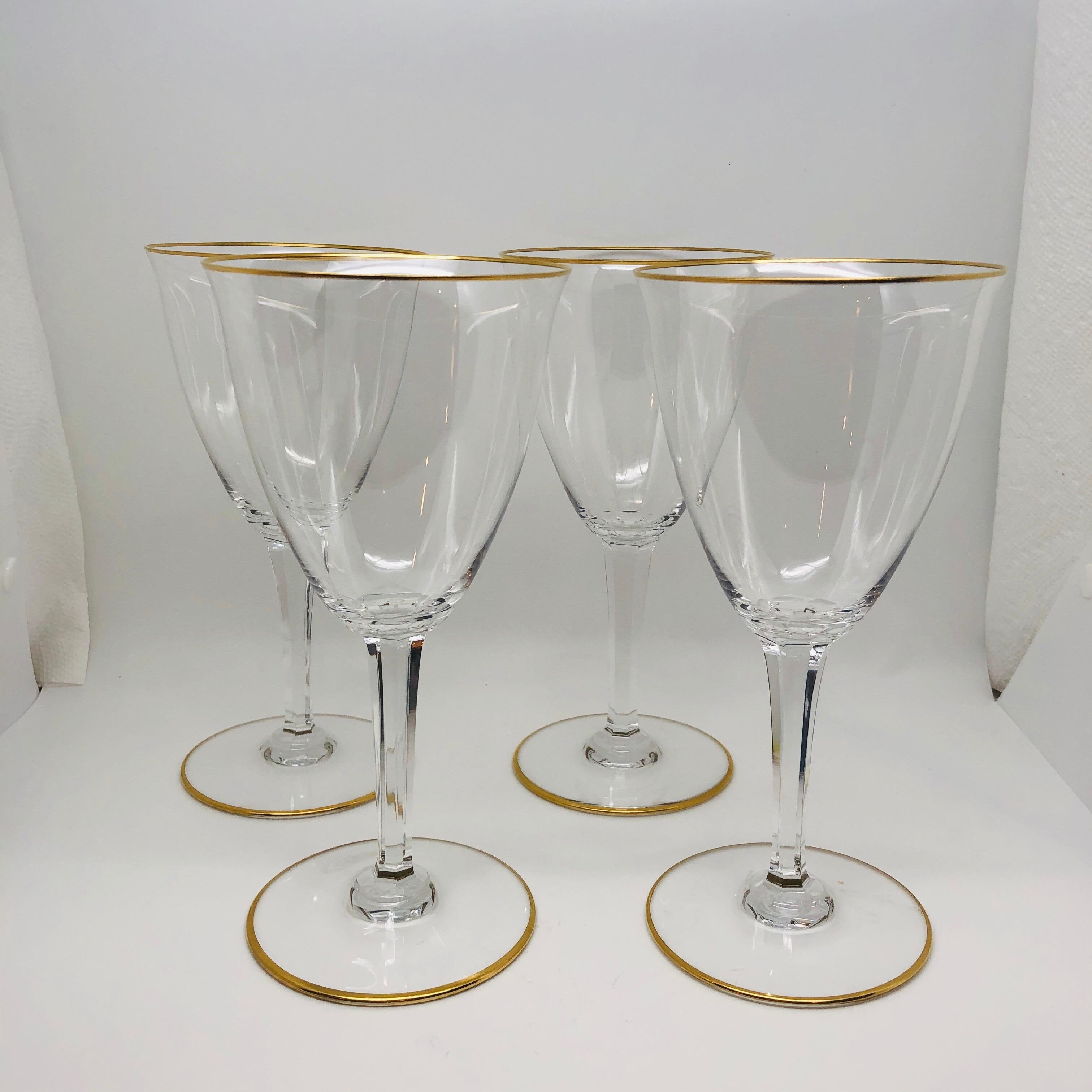 Set of twelve signed Baccarat goblets with gold trimmed tops and bottoms. They are in excellent condition. They are a perfect goblet to serve your special vintage wine. Their form is an example of simple elegance. They are 7 1/2 inches tall and the