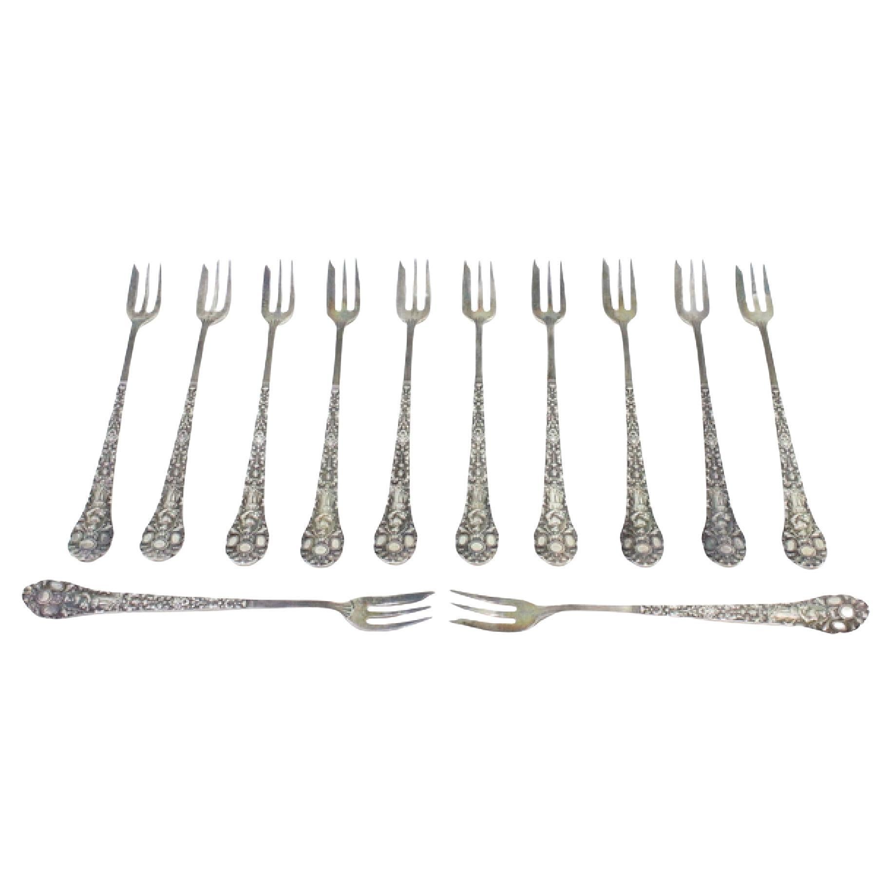 Set of twelve silver cake forks with revealed and crimped handles