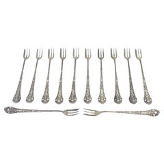 Set of twelve silver cake forks with revealed and crimped handles