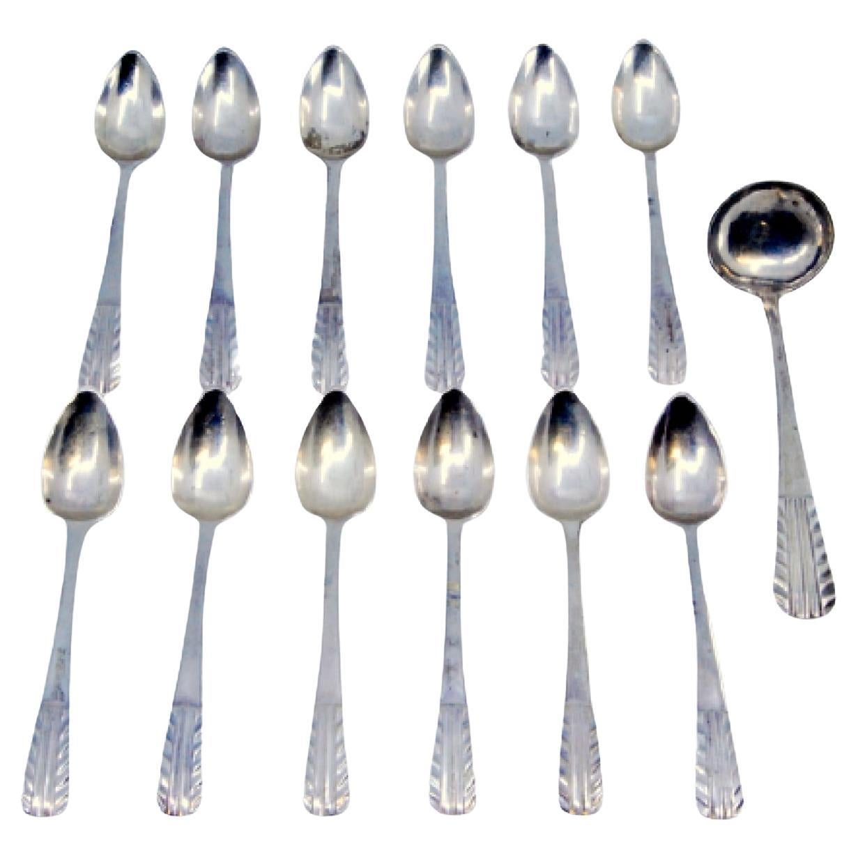 Set of twelve silver coffee spoons and sugar ladle with raised handles