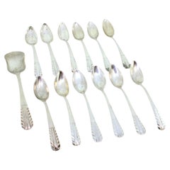 Set of twelve silver coffee spoons and sugar shovel with raised handles