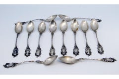 Set of twelve silver coffee spoons with cut and embossed handles