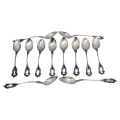 Set of twelve silver coffee spoons with cut and embossed handles
