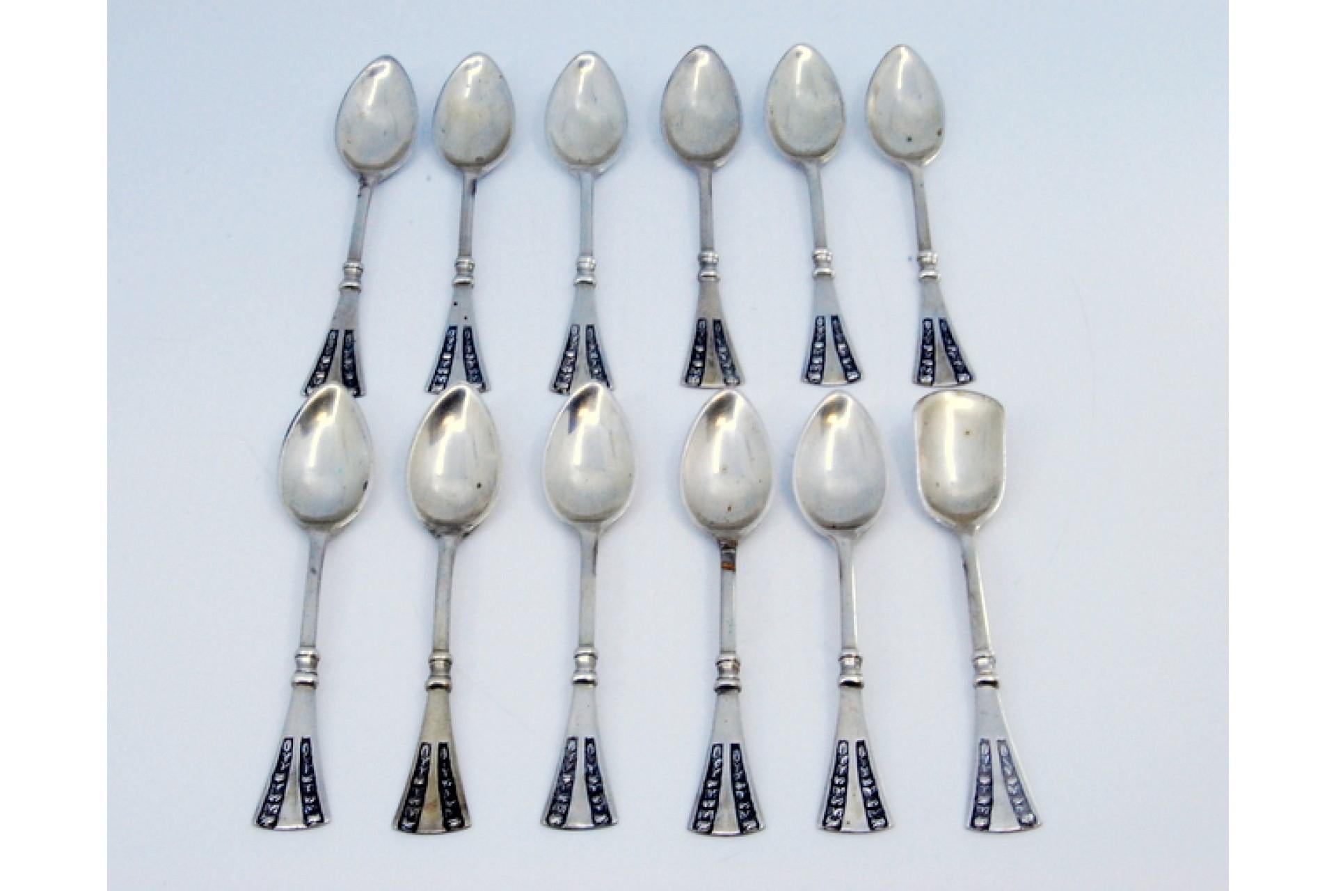 Description: Set of twelve silver coffee spoons with floral motifs on the handles. Metal: Silver. Origin: Portuguese. Brand: javali II Title. Weight: 206.94g (Set of twelve spoons). Dimensions: 11.5x2.2cm. Content: 833/1000. Assay Mark: Yes, between