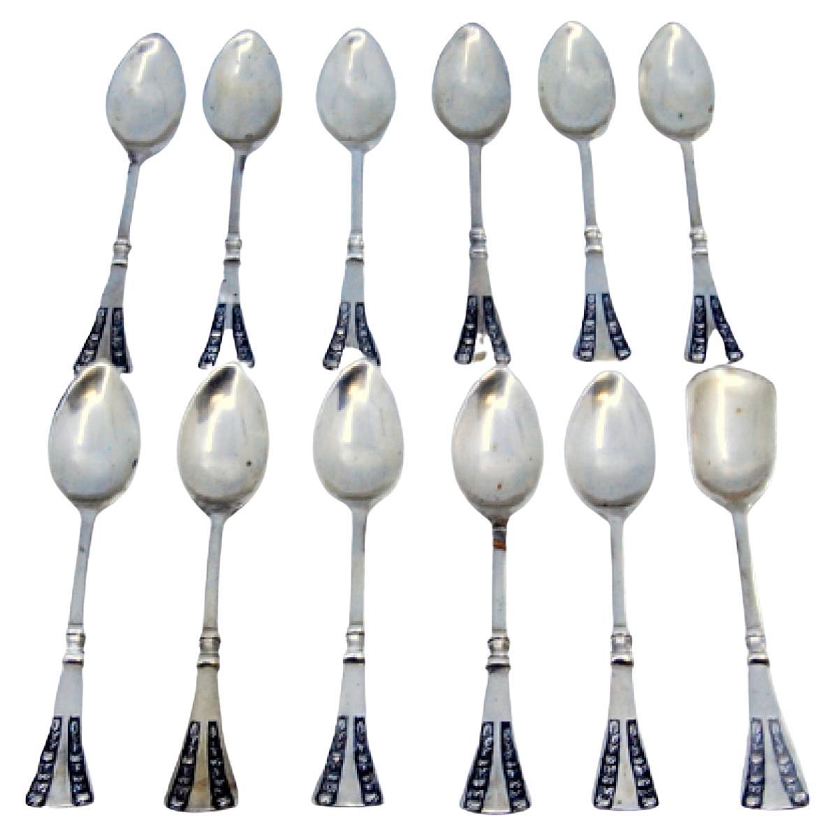 Set of twelve silver coffee spoons with floral motifs on the handles