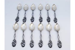 Set of twelve silver coffee spoons with scalloped handles