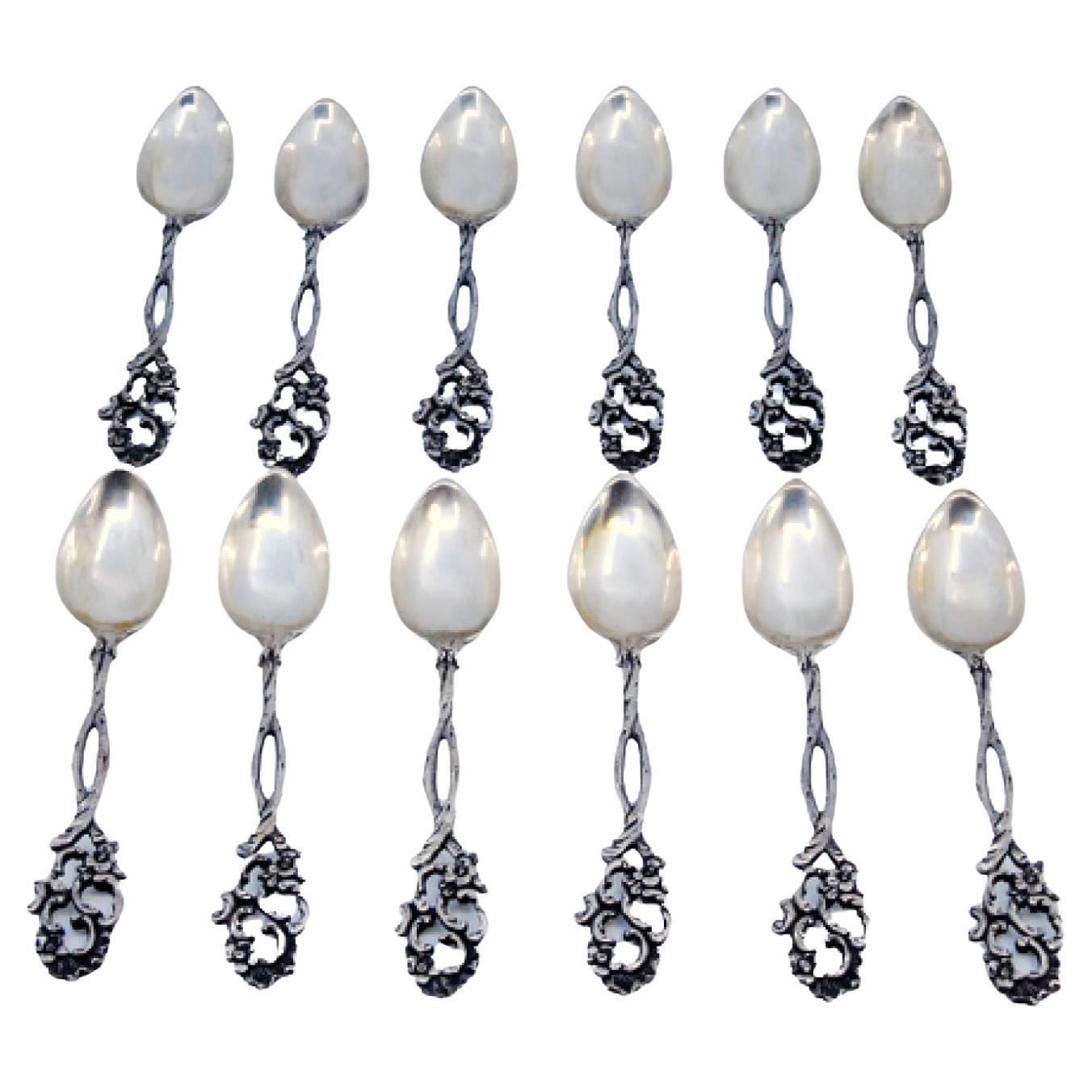 Set of twelve silver coffee spoons with scalloped handles
