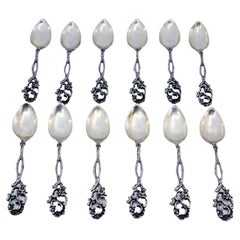 Set of twelve silver coffee spoons with scalloped handles