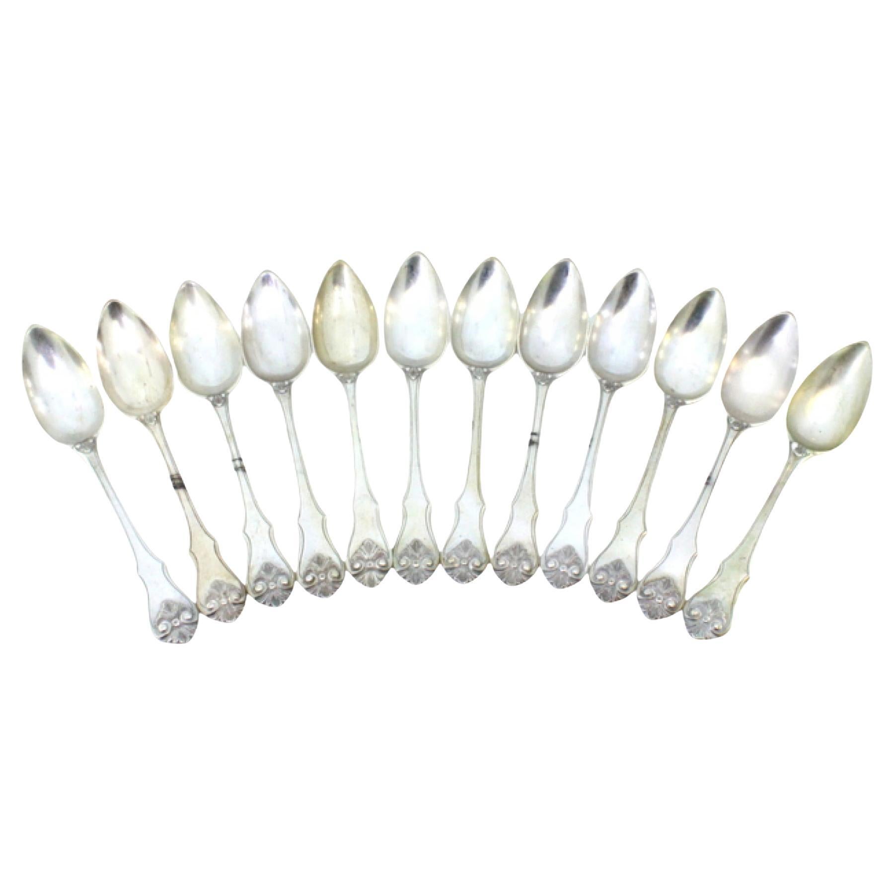 Set of twelve silver dessert spoons with raised handles