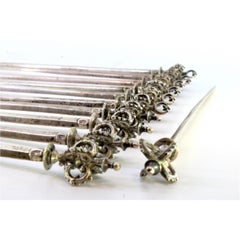 Set of twelve silver florets with openwork crown-shaped handles